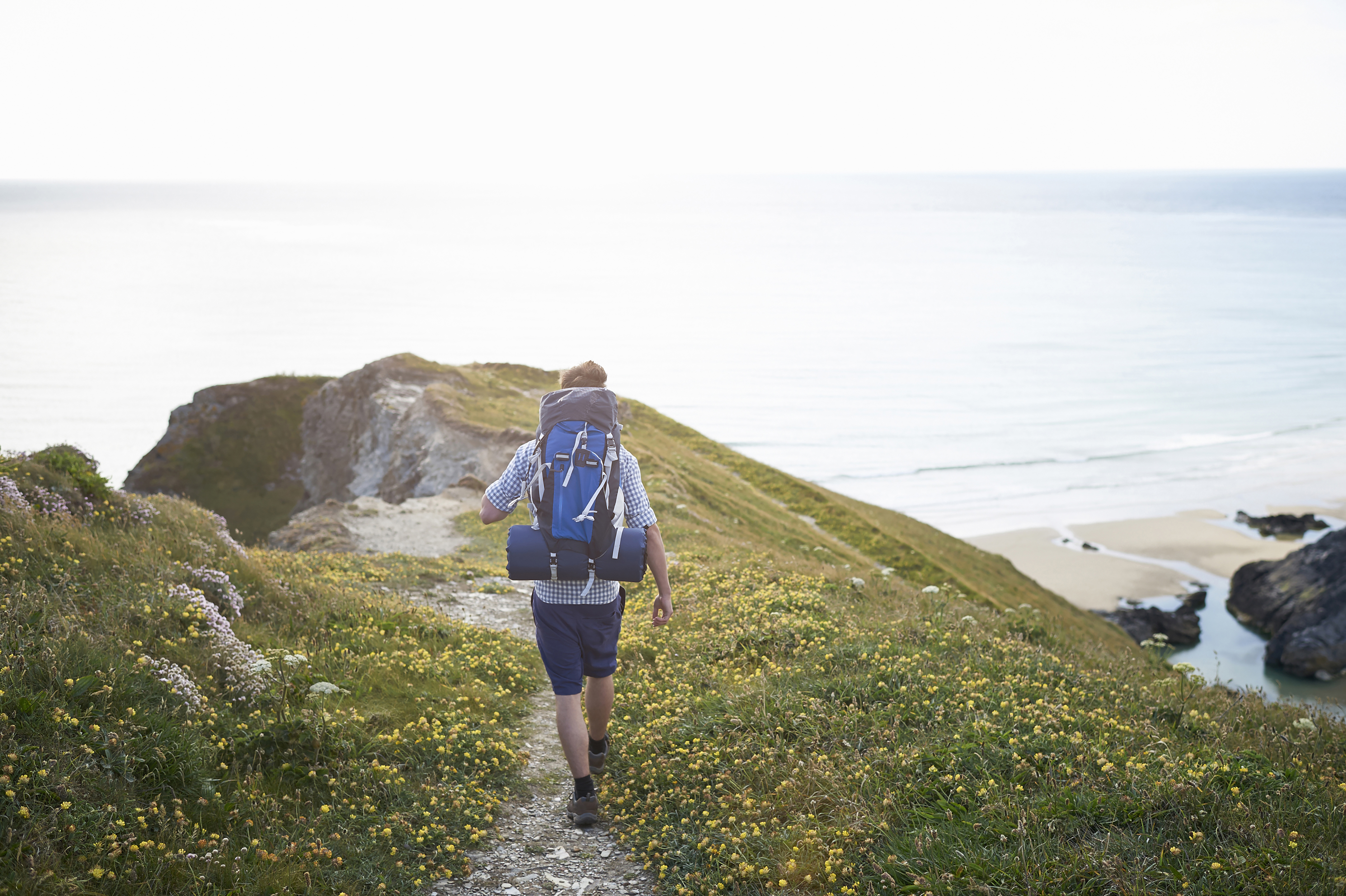 Hiker walking along coastal path