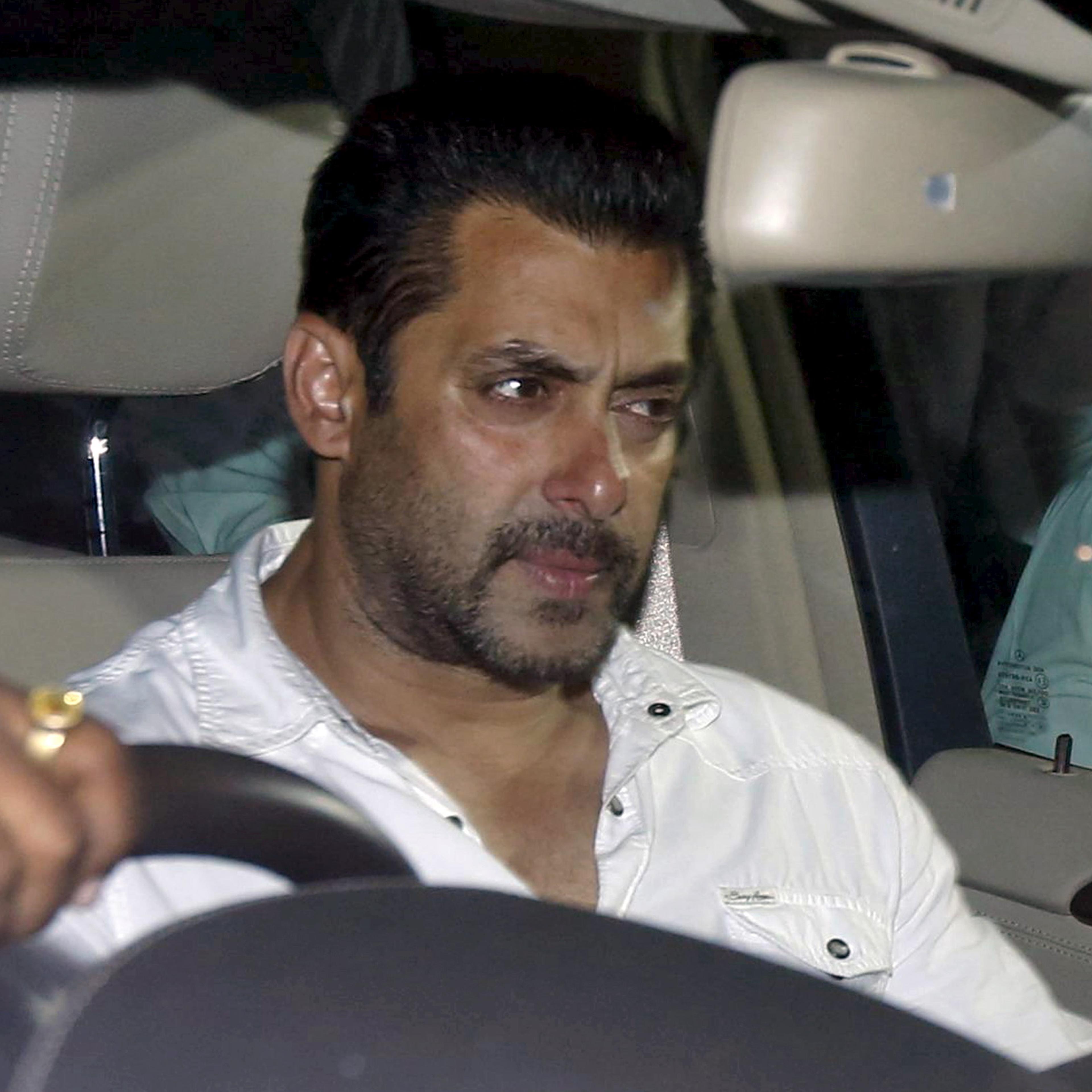 Bollywood actor Salman Khan sits in a car as he leaves a court in Mumbai