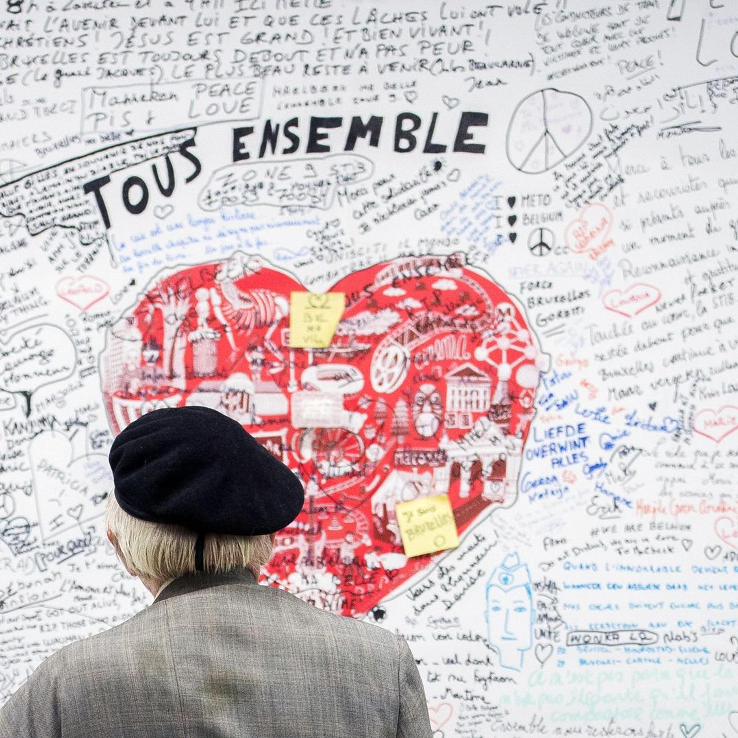 A man looks at a memorial panel for the victims of the March 22 attacks at the entrance of the Maelbeek-Maalbeek subway station in Brussels on May 11, 2016.