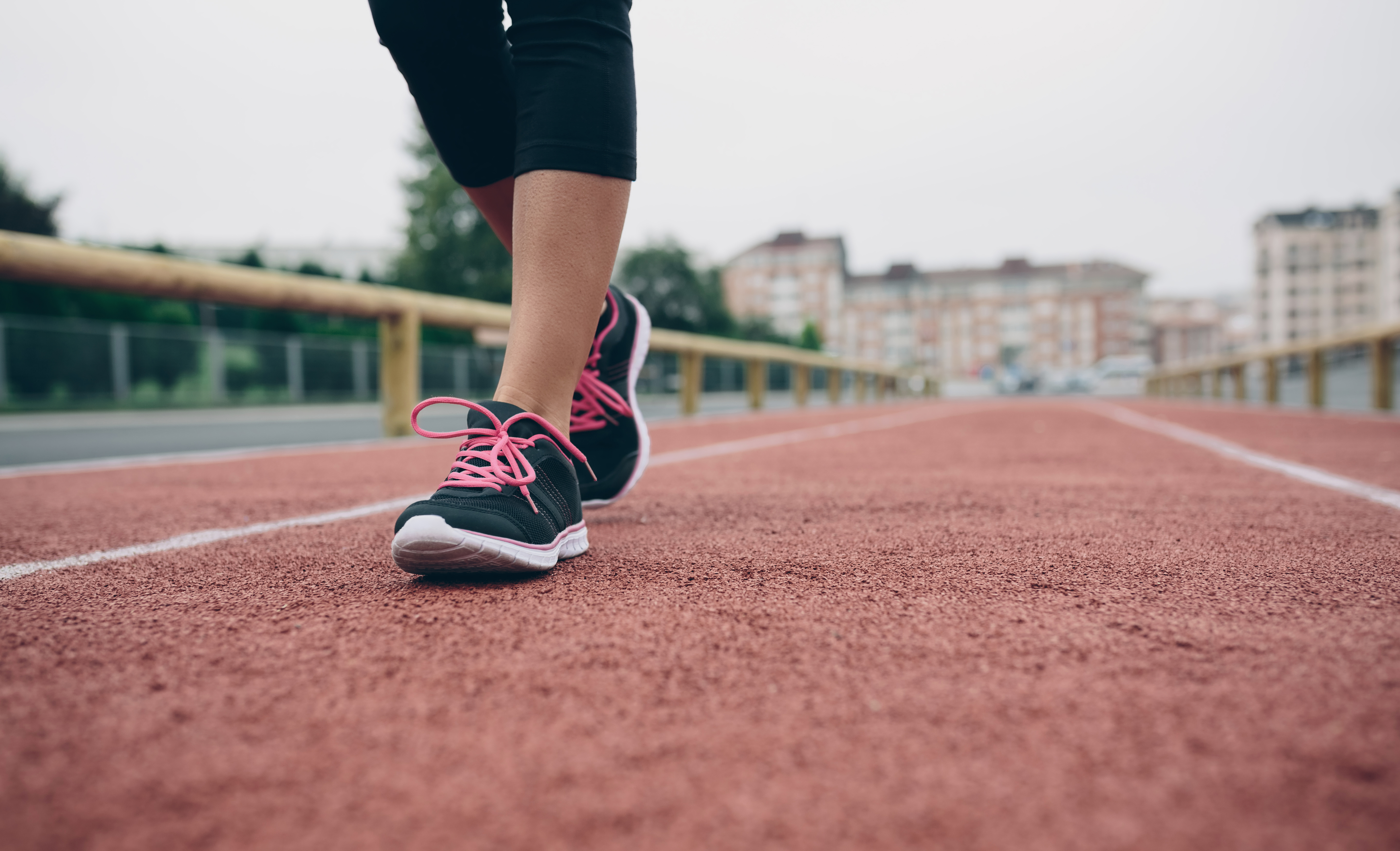 Woman walking on tartan track