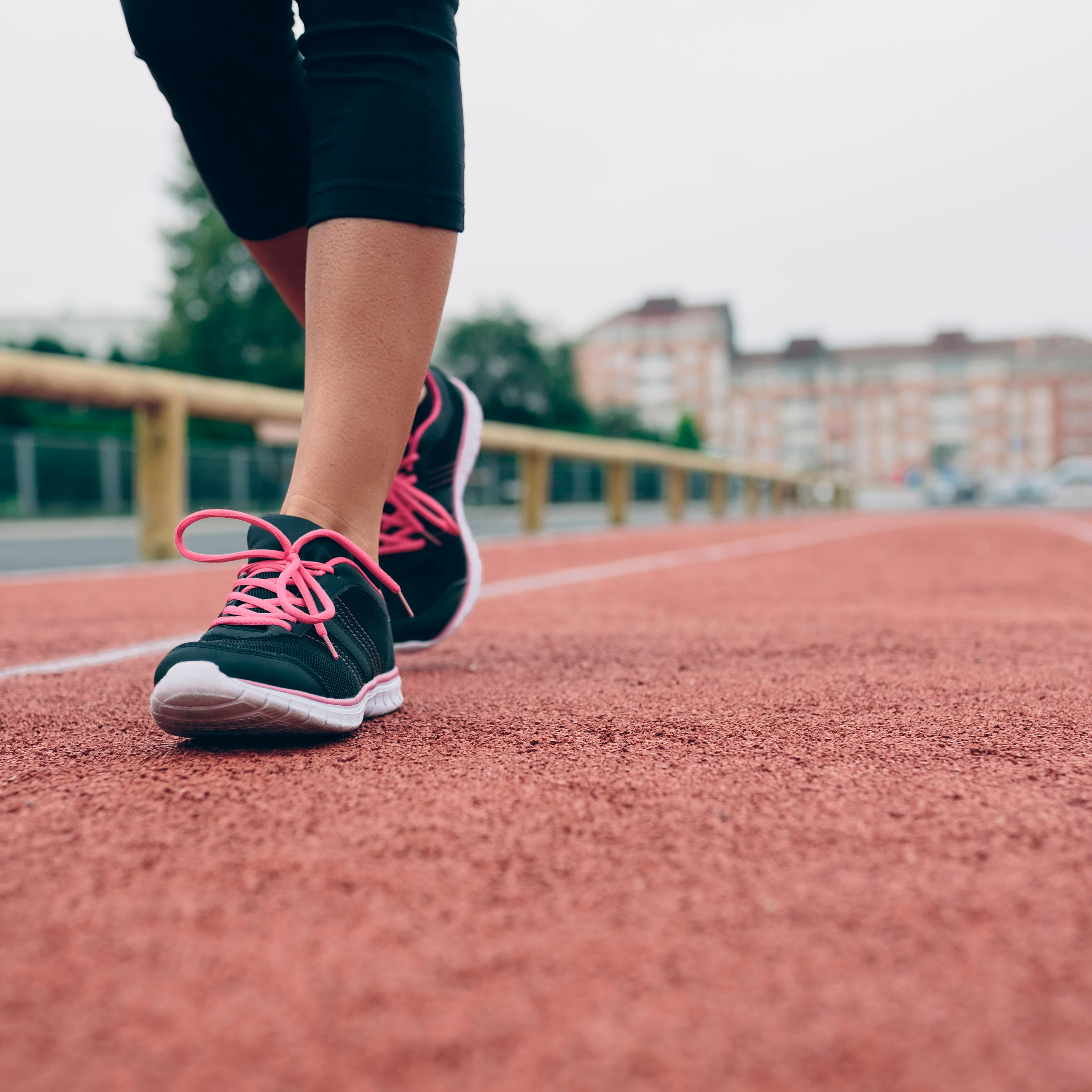 Woman walking on tartan track