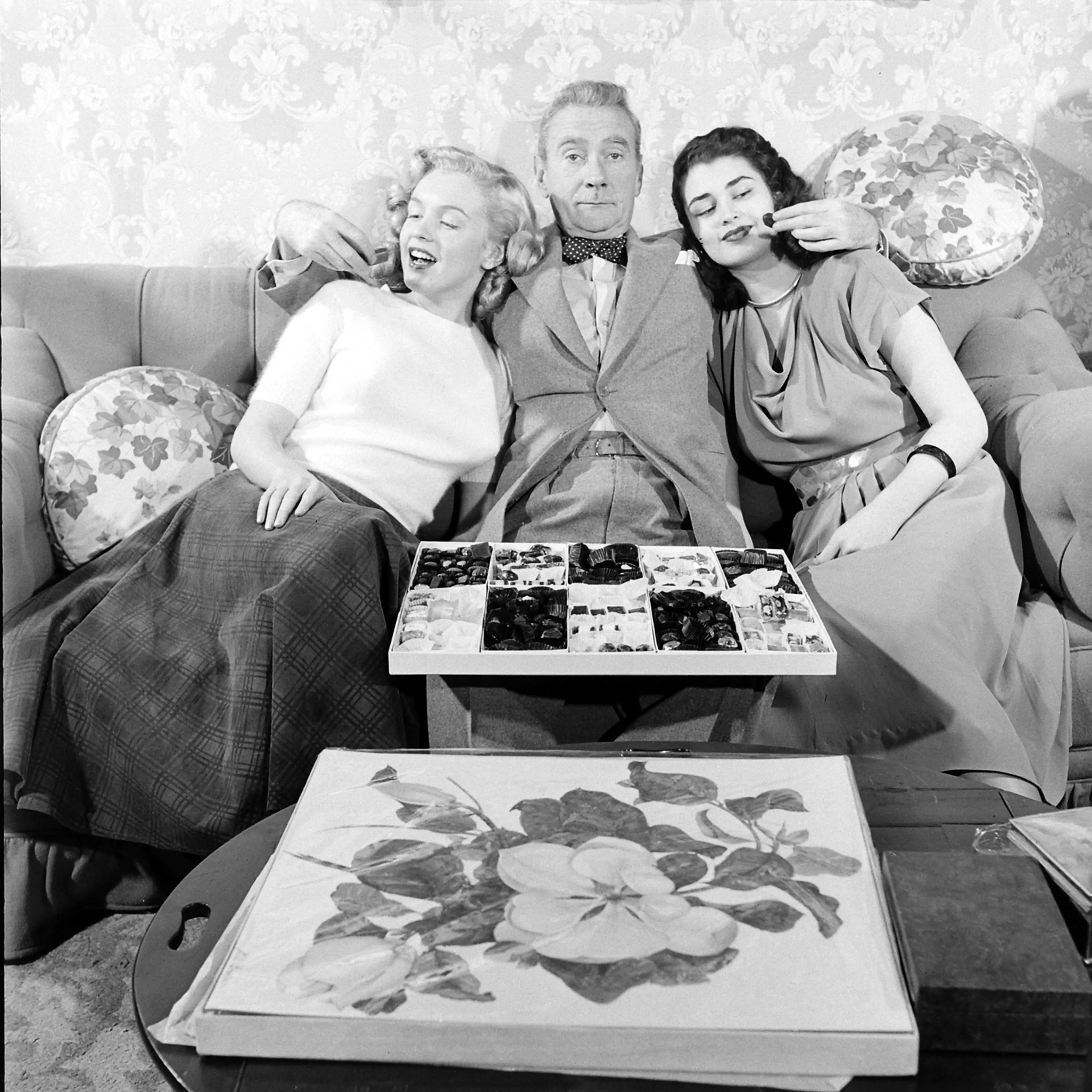 Then-unknown actress Marilyn Monroe with Clifton Webb and Laurette Luez on the set of a 1948 comedy, "Sitting Pretty."