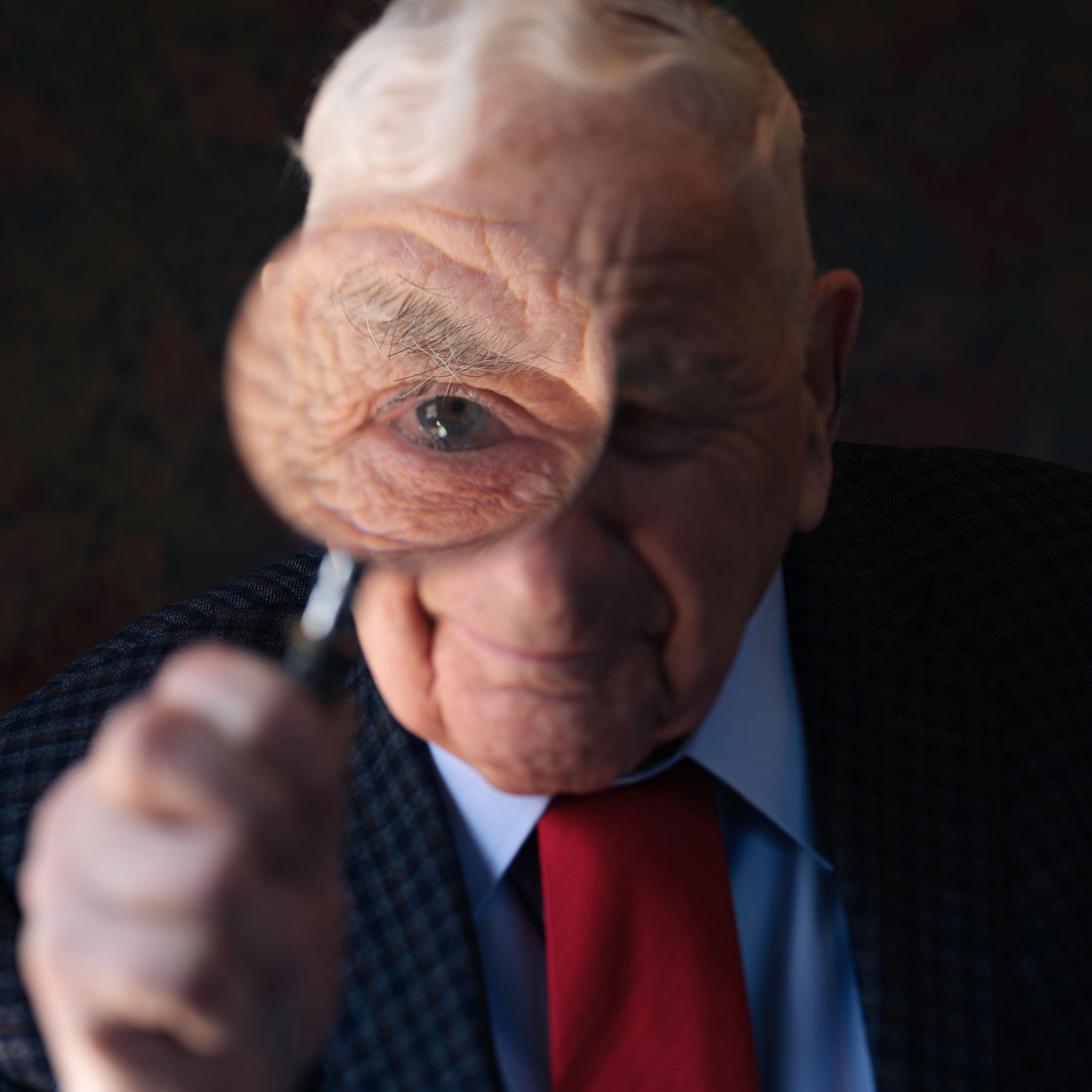 A portrait of Dr. Spitz and his magnifying glass.
