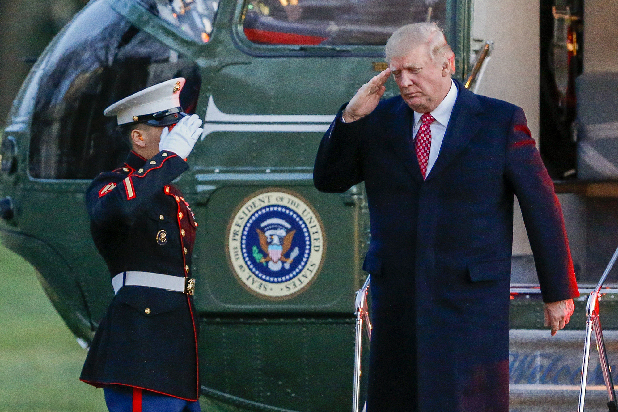 Donald Trump salutes as he disembarks Marine One on the South Lawn of the White House in Washington, D.C., on March 5, 2017.