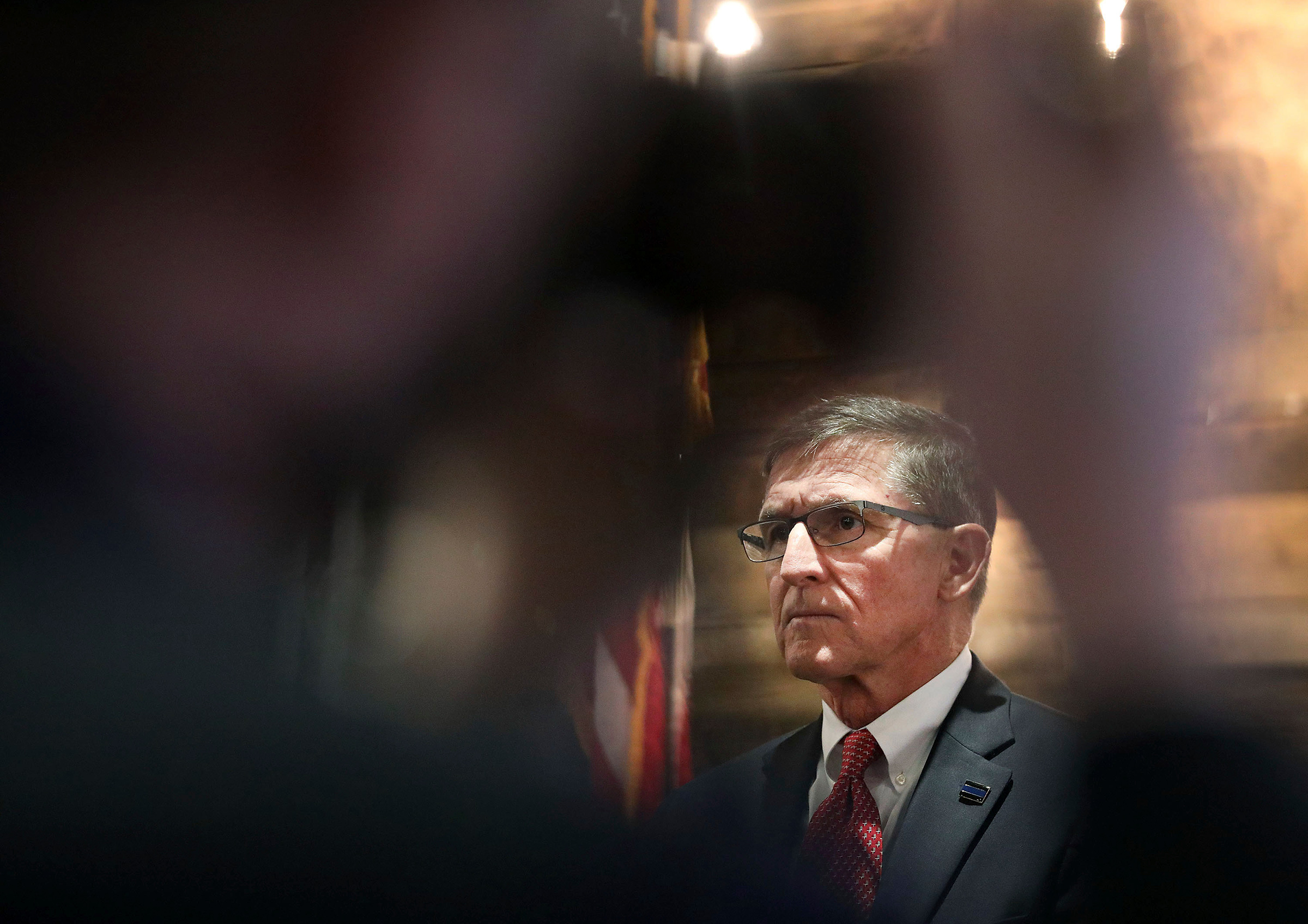 A journalist takes a photo of Retired Gen. Michael Flynn, former National Security Advisor under President Donald Trump, as he takes part in the announcement for Pastor Jackson Lahmeyer's run for the United States Senate, Tuesday, March 16, 2021 in Jenks, Okla. 