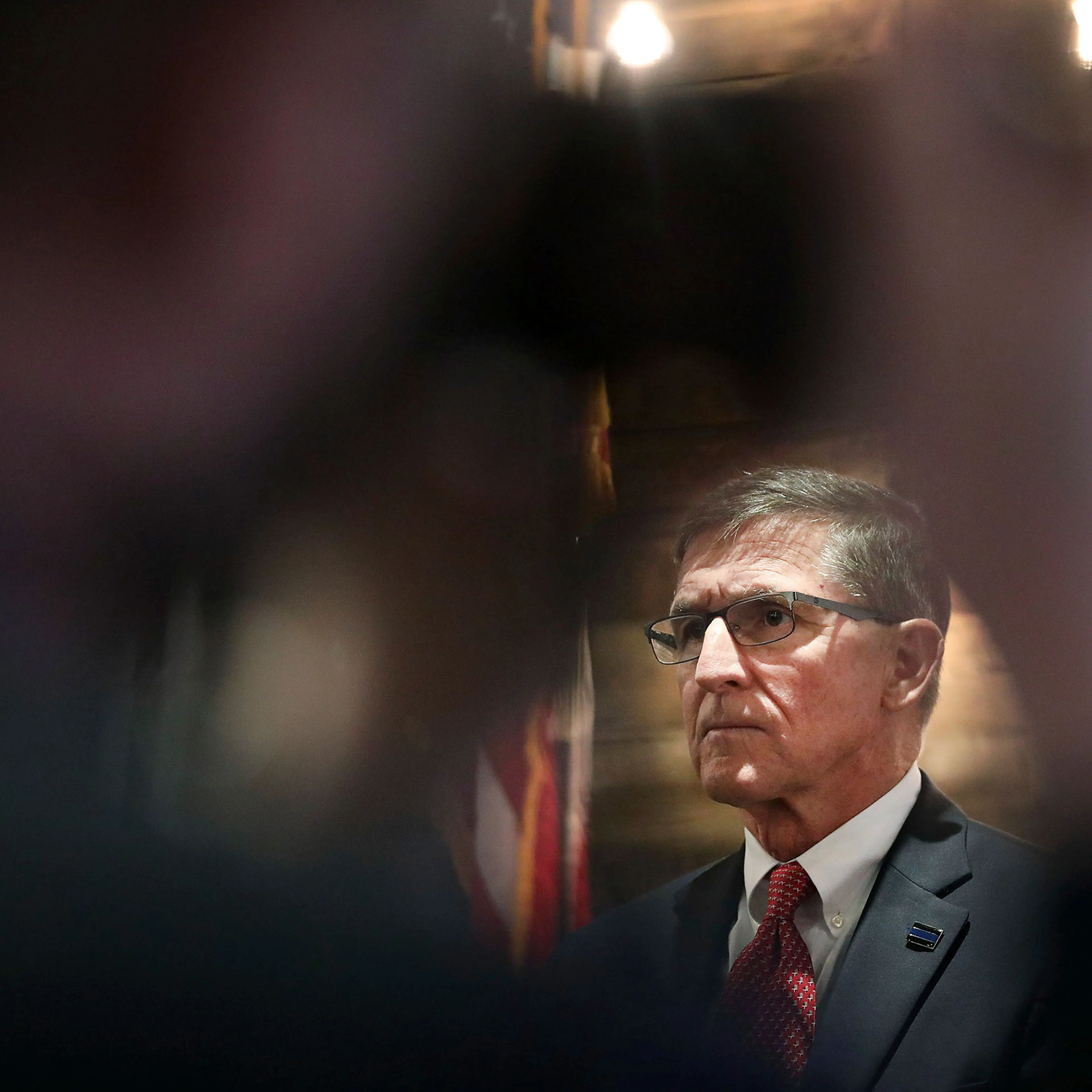 A journalist takes a photo of Retired Gen. Michael Flynn, former National Security Advisor under President Donald Trump, as he takes part in the announcement for Pastor Jackson Lahmeyer's run for the United States Senate, Tuesday, March 16, 2021 in Jenks, Okla.