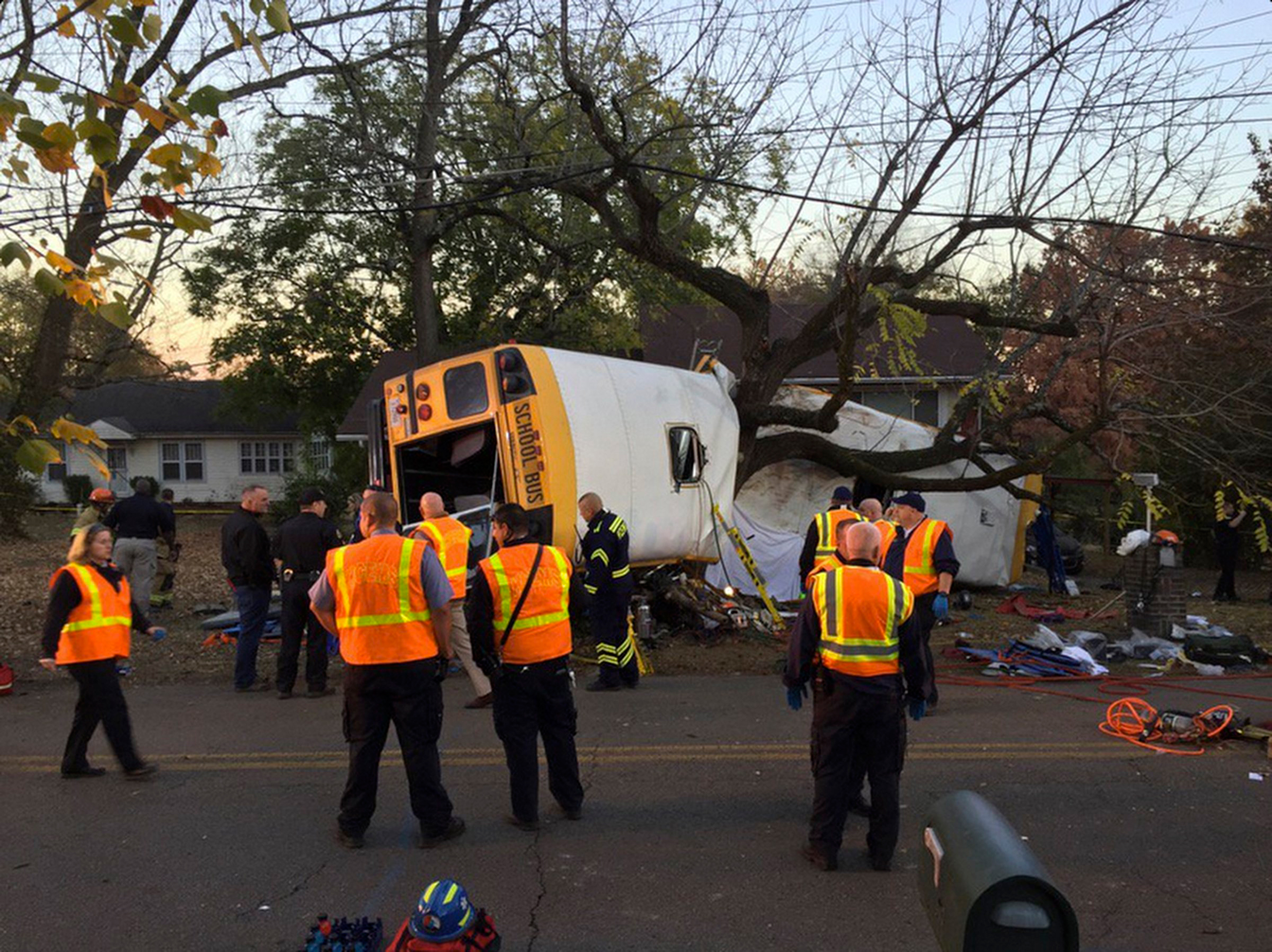 In this photo provided by the Chattanooga Fire Department via Chattanooga Times Free Press, Chattanooga Fire Department personnel work the scene of a fatal elementary school bus crash in Chattanooga, Tenn., Monday, Nov. 21, 2016. In a news conference Mon