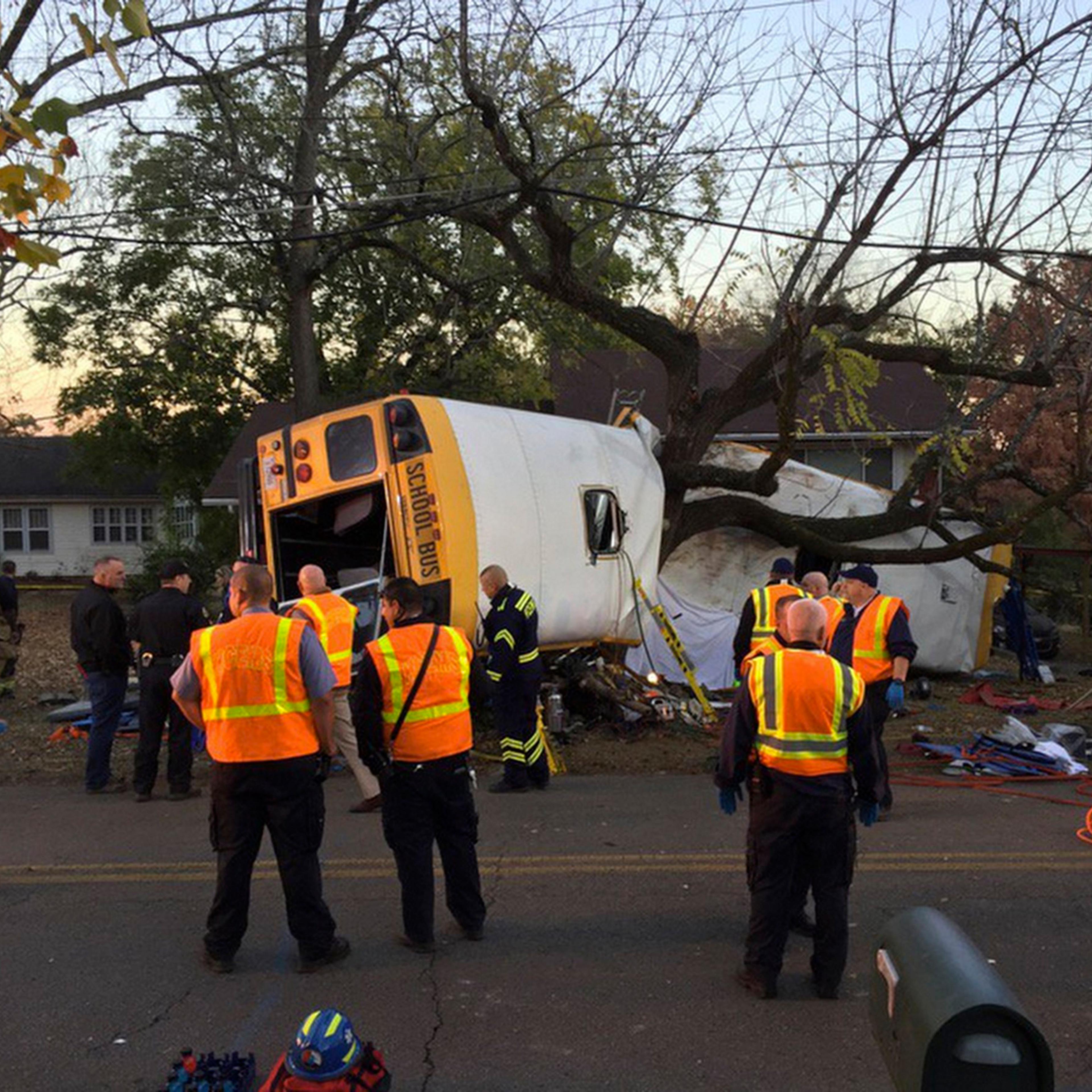 In this photo provided by the Chattanooga Fire Department via Chattanooga Times Free Press, Chattanooga Fire Department personnel work the scene of a fatal elementary school bus crash in Chattanooga, Tenn., Monday, Nov. 21, 2016. In a news conference Mon