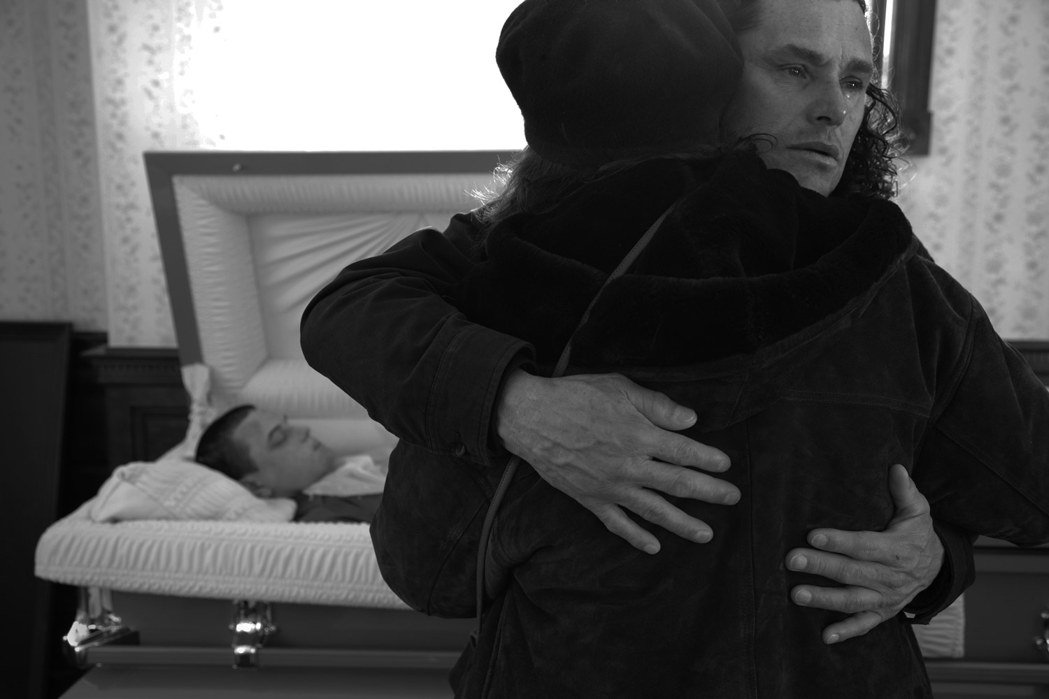 Carlos Arredondo holds his wife before leaving the viewing. Jamaica Plain, Mass., Dec. 26, 2011. 