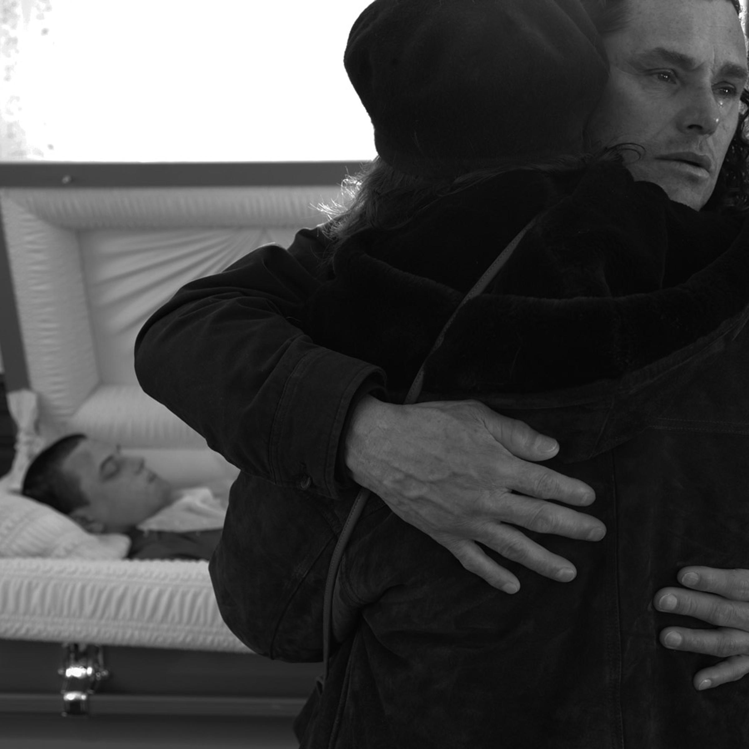 Carlos Arredondo holds his wife before leaving the viewing. Jamaica Plain, Mass., Dec. 26, 2011.