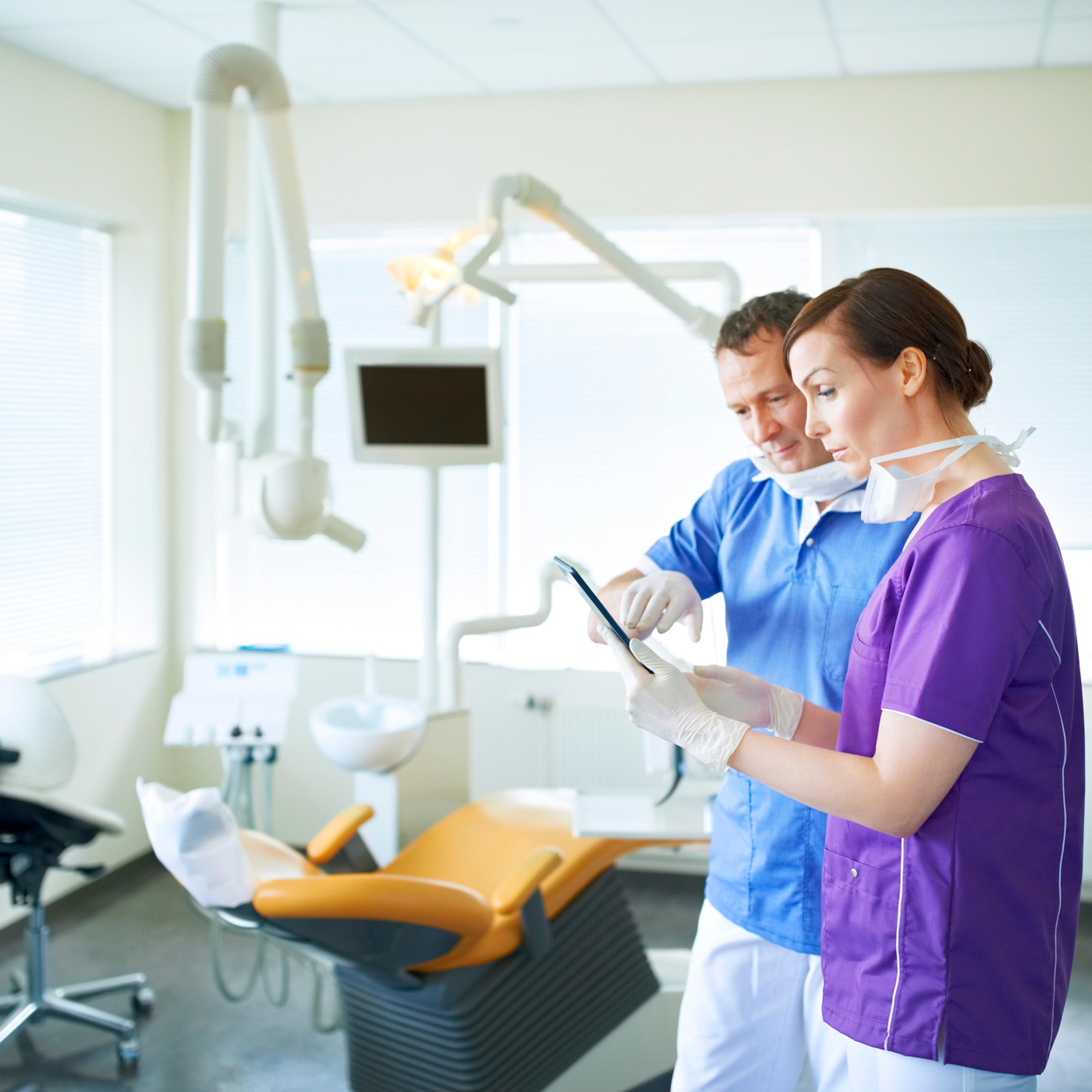Two dentists comparing notes