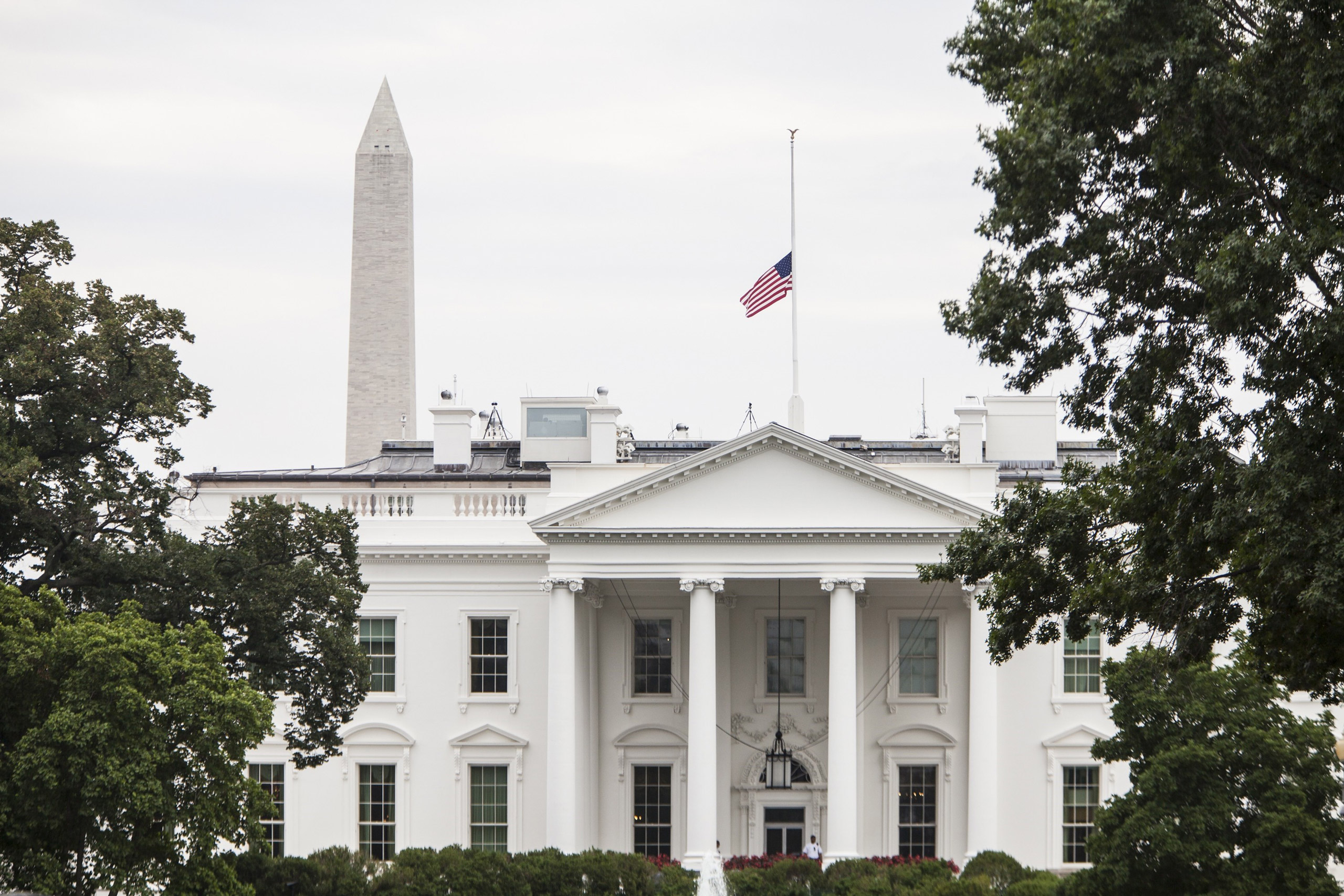 WASHINGTON, USA - JULY 21: The American Flag flies above the White House after President Barack Obama ordered it lowered to half staff in honor of the four Marines and one Sailor killed in Chattanooga, TN in Washington, USA on JULY 21, 2015. (Photo by Sa