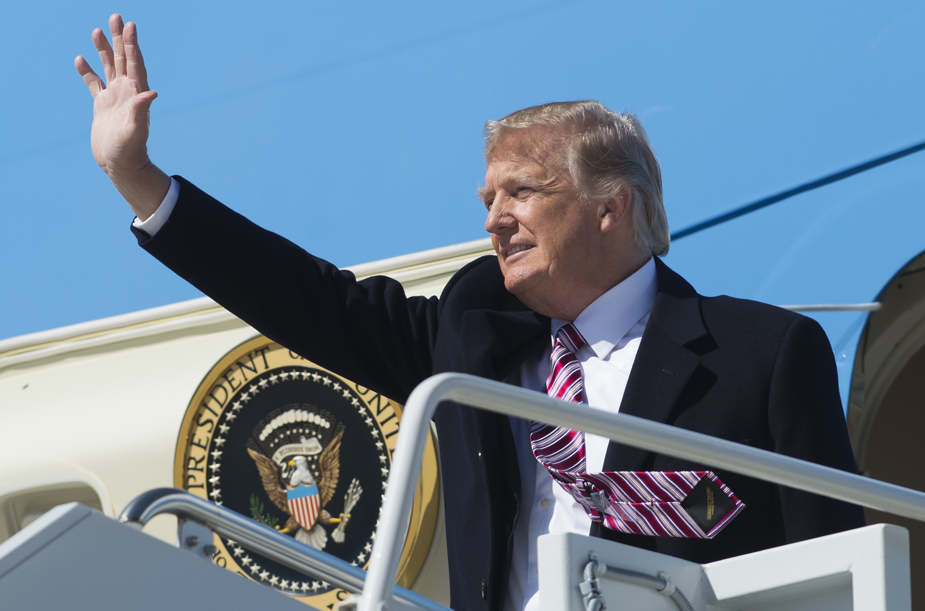 US President Donald Trump waves from Air Force One upon arrival at Langley Air Force Base in Virginia, March 2, 2017