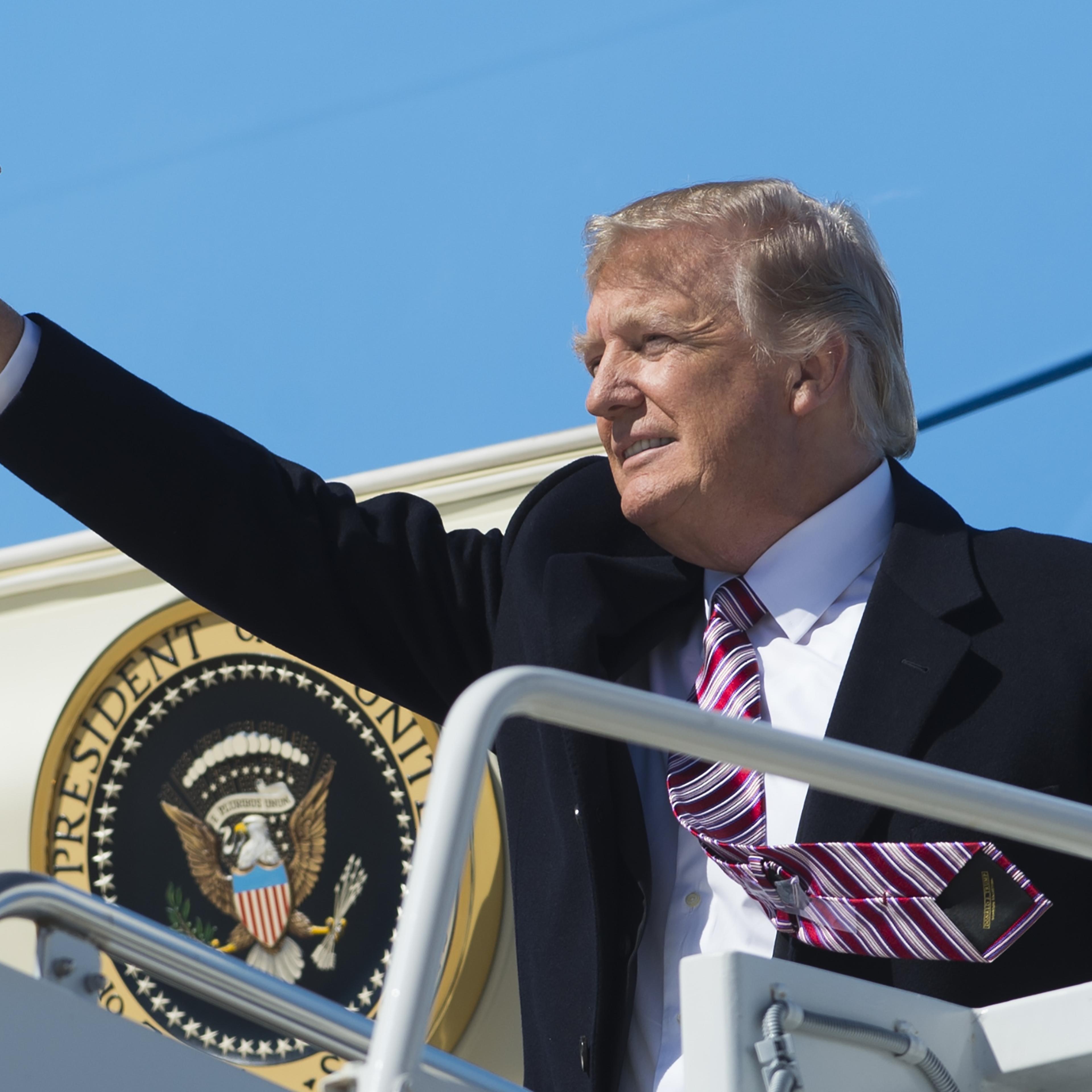 US President Donald Trump waves from Air Force One upon arrival at Langley Air Force Base in Virginia, March 2, 2017