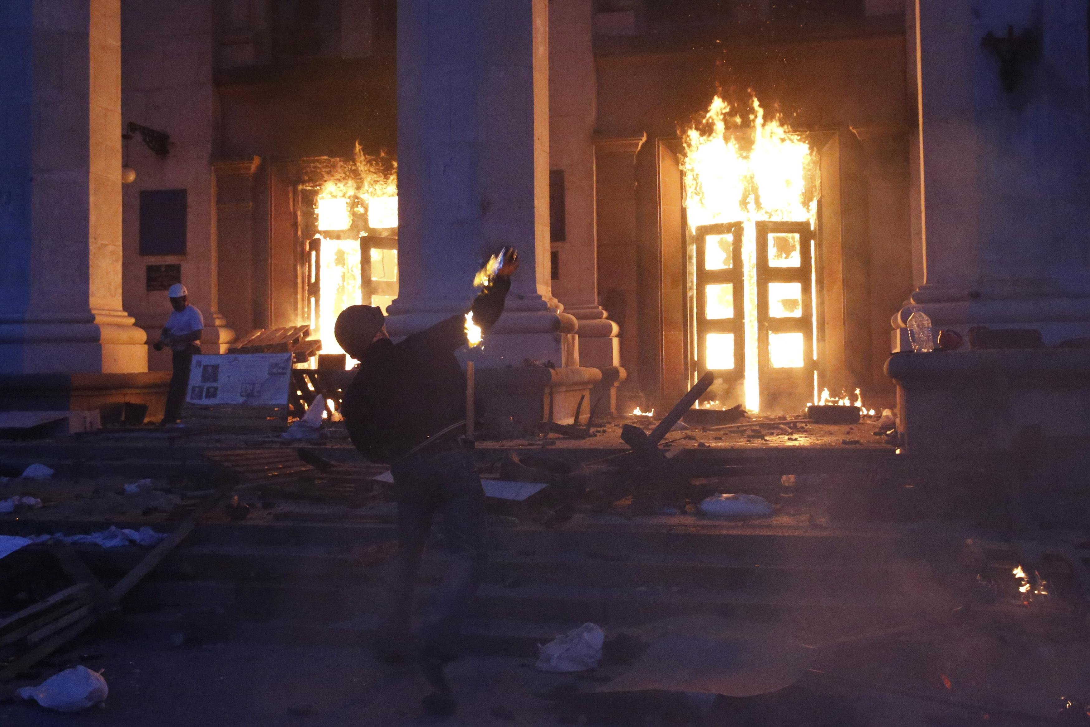 A protester throws a petrol bomb at the trade union building in Odessa