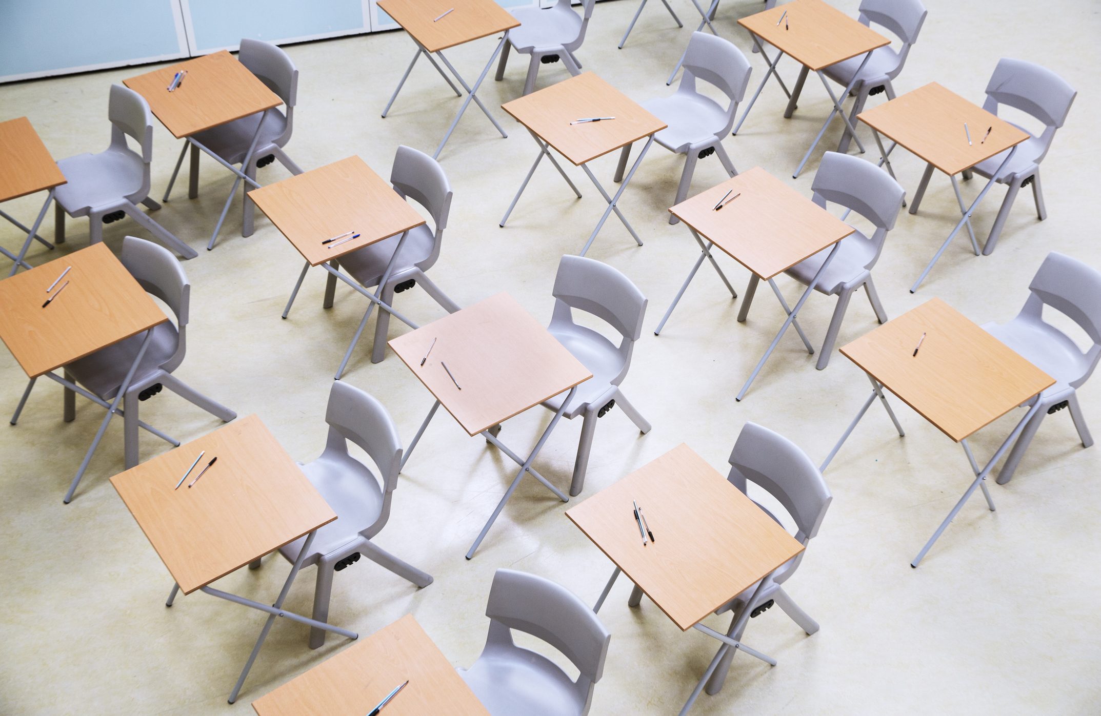 Elevated view of rows of desks and chairs in empty classroom