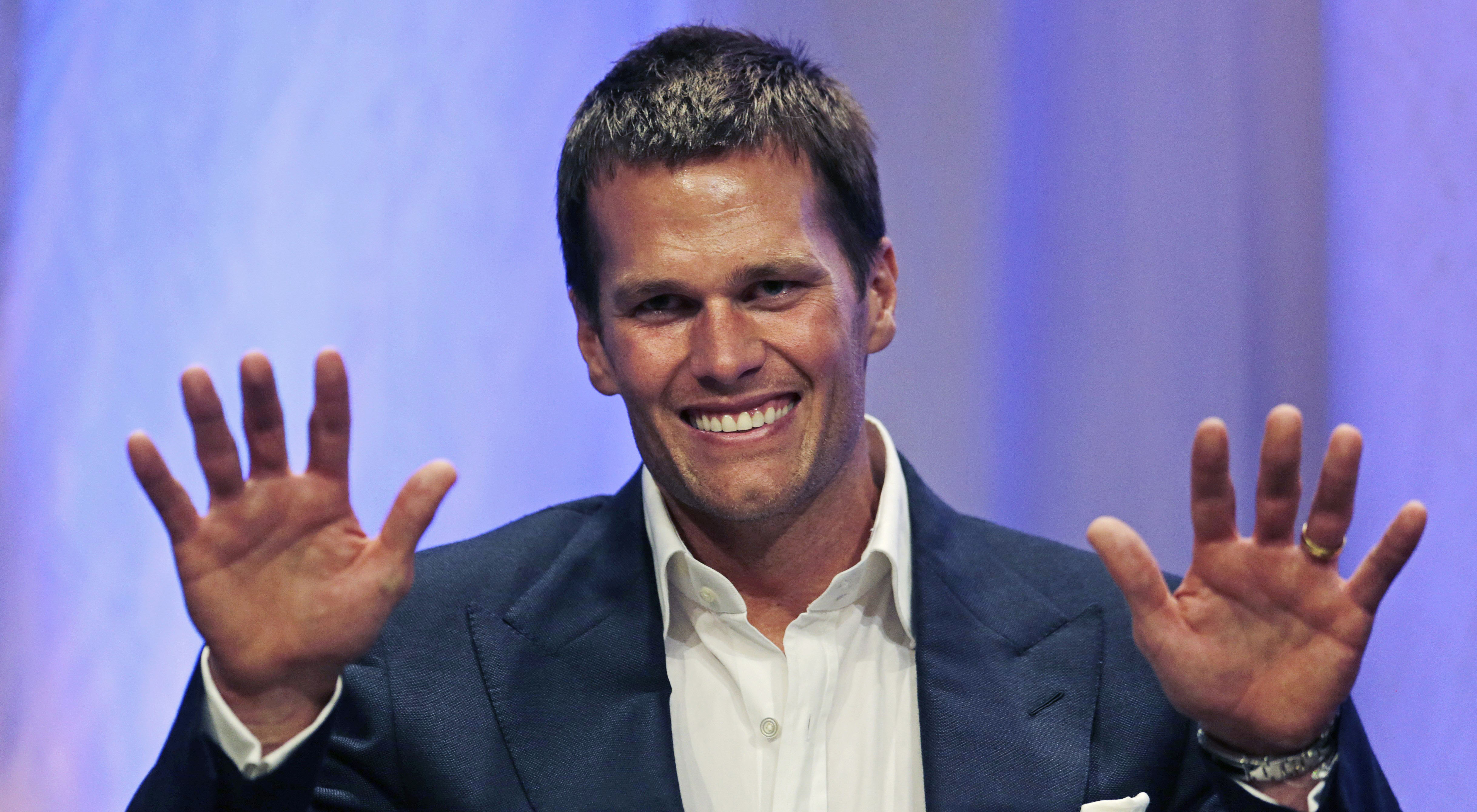 New England Patriots quarterback Tom Brady gestures during an event at Salem State University in Salem, Mass.