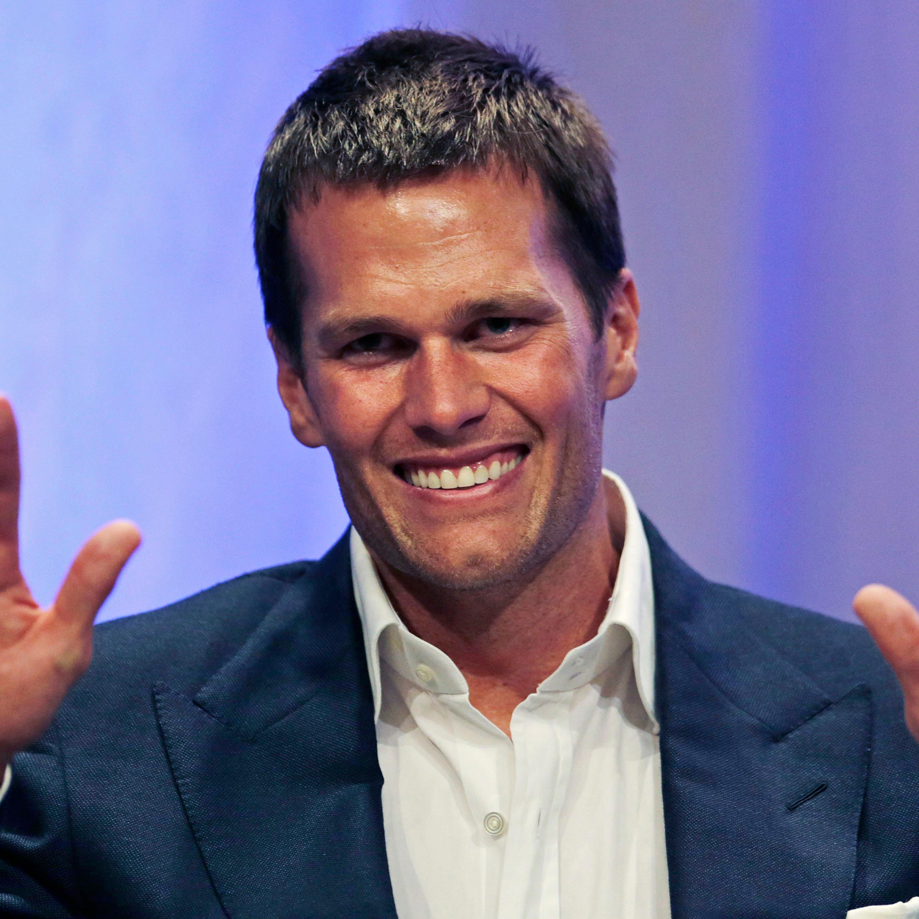 New England Patriots quarterback Tom Brady gestures during an event at Salem State University in Salem, Mass.