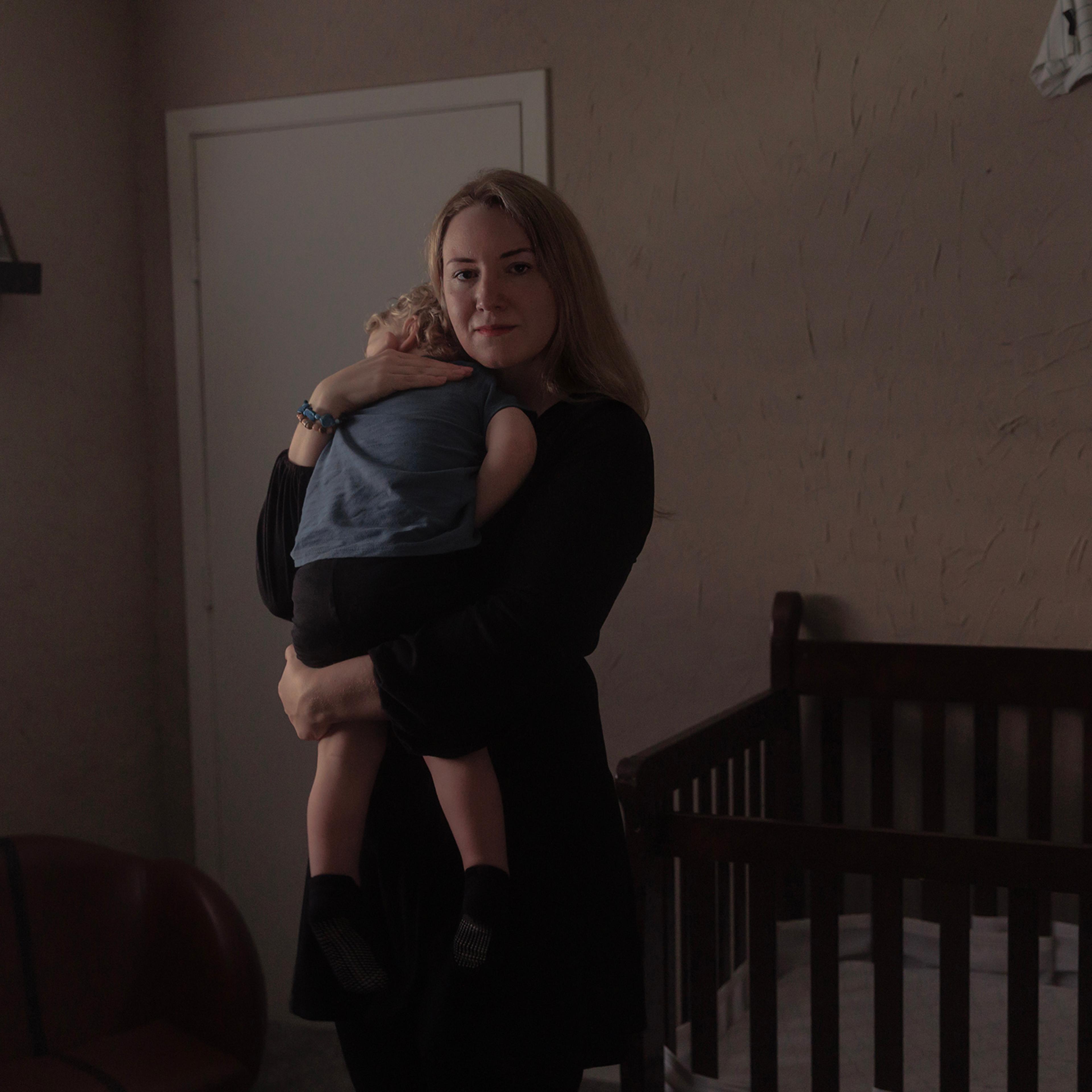 Kate Cox holds her son before putting him down for a nap at home on March 3.