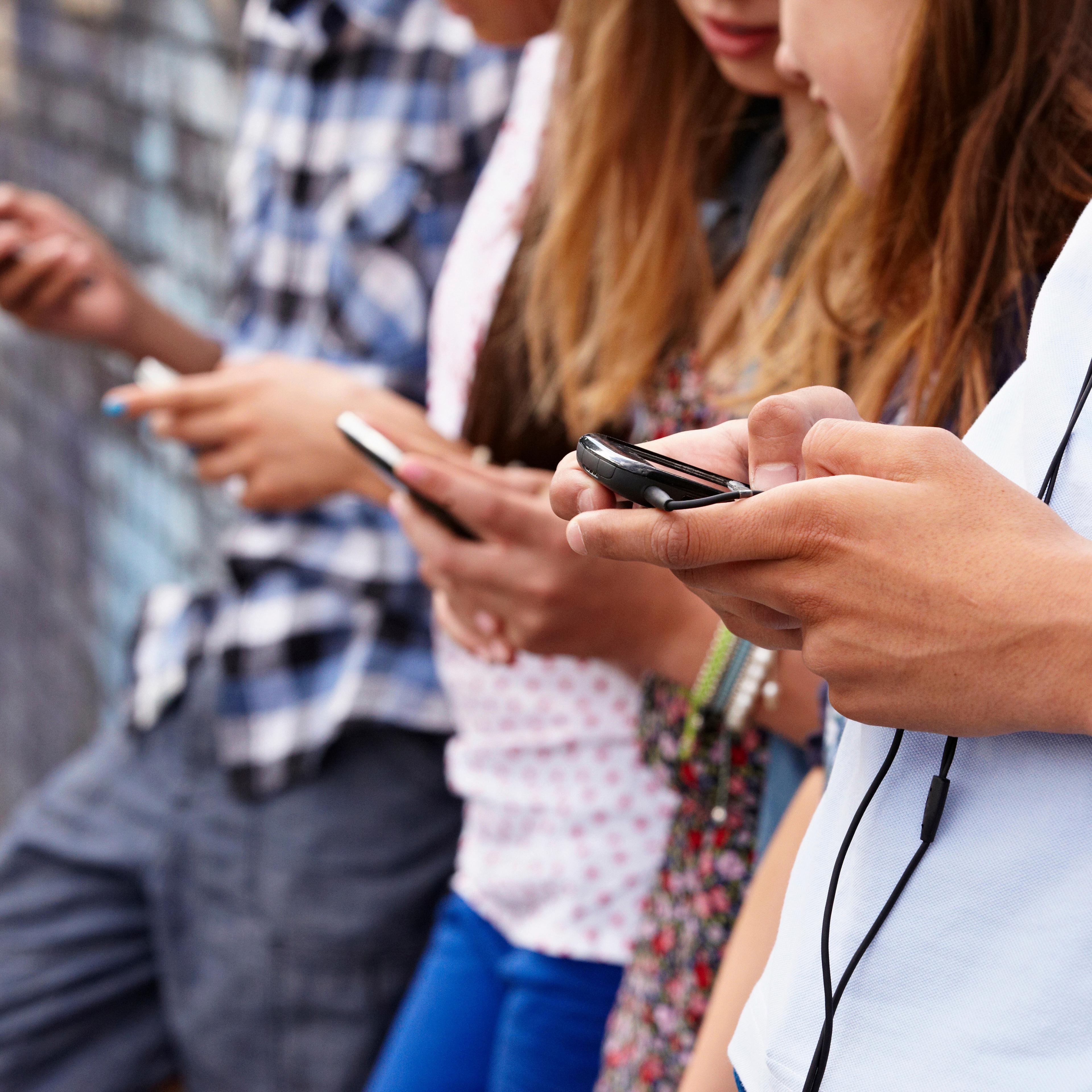 Teenagers using cellphones