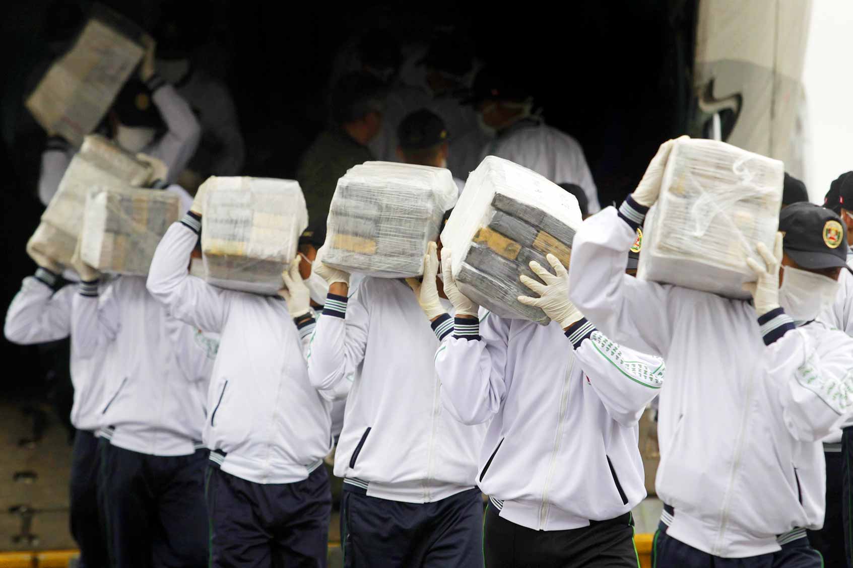  Peruvian police with cocaine seized in a recent drug raid. 
A record 6.7 million metric tons was taken at the end of August