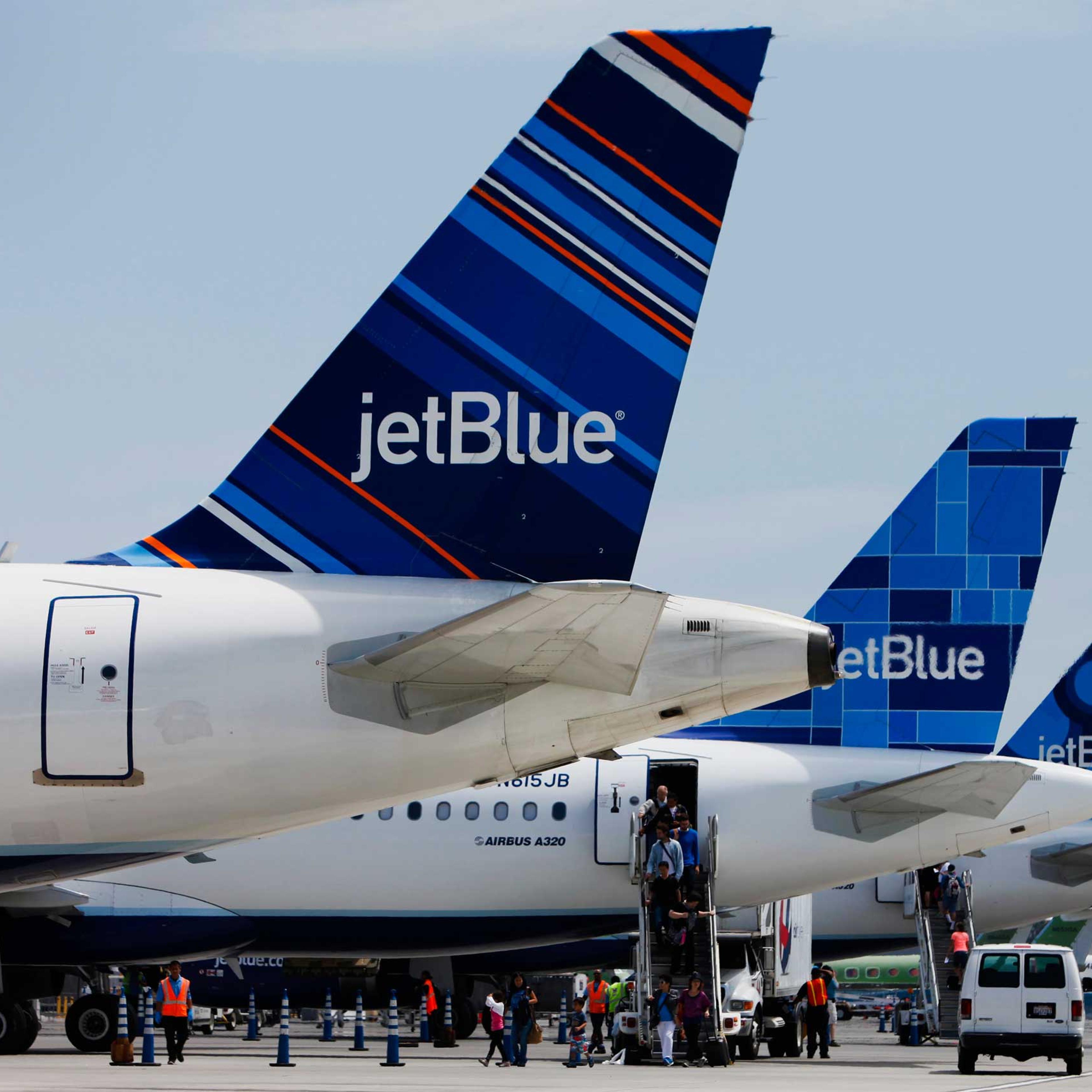 Passengers exit a JetBlue Airways Corp. plane at Long Beach Airport (LGB) in Long Beach, California, U.S., on Monday, July 22, 2013.