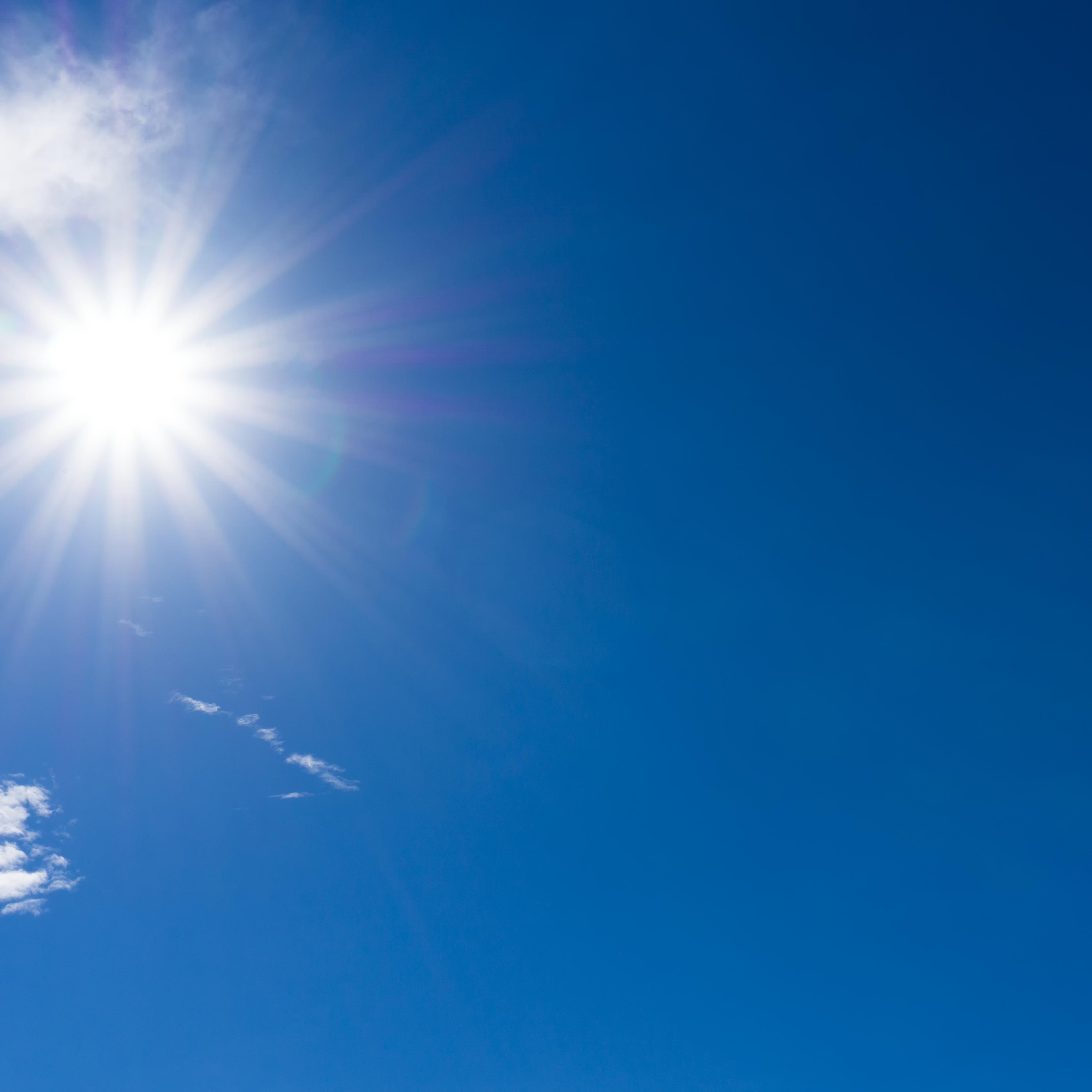 Blue Sky and Clouds with Sunburst