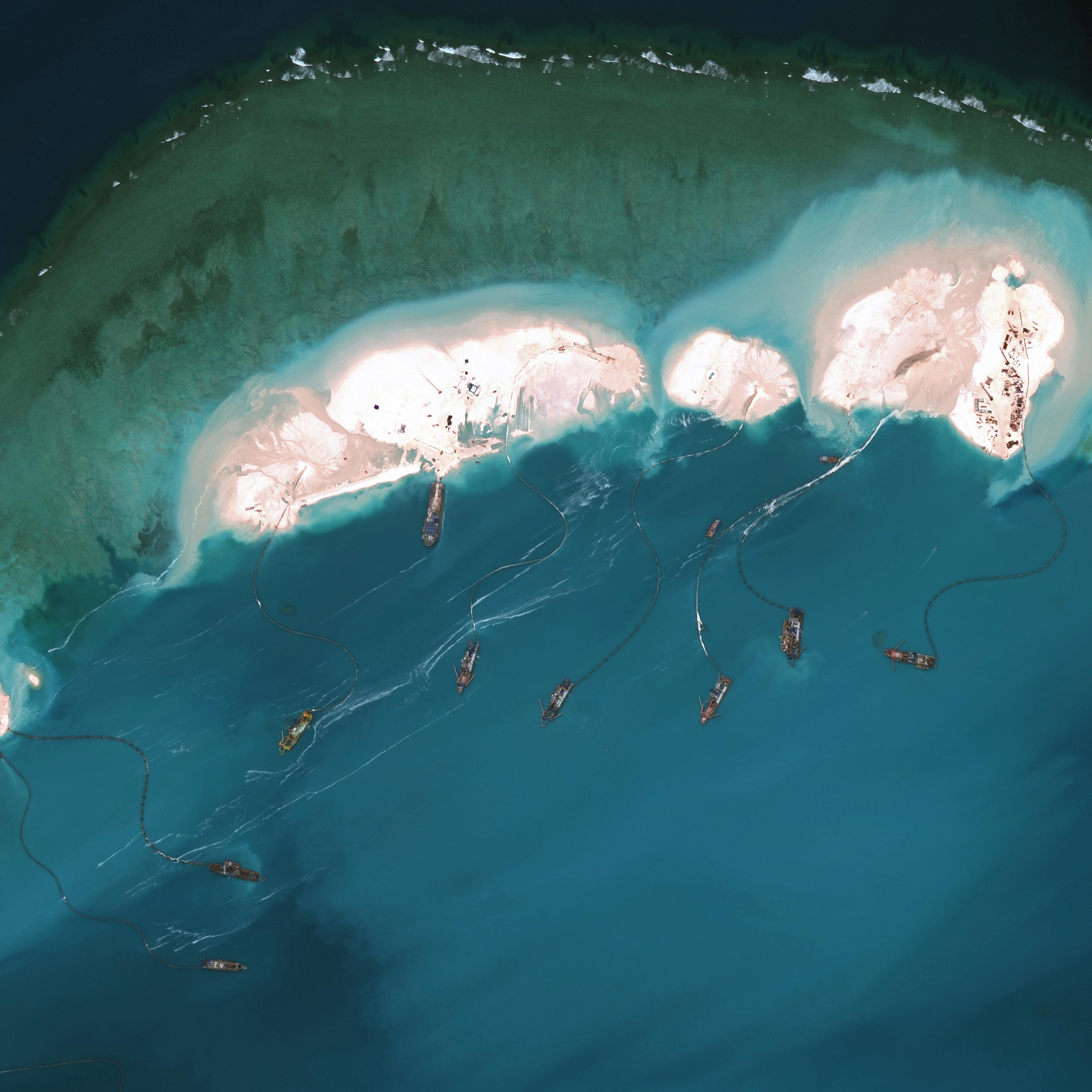 DigitalGlobe imagery from 16 March 2015 shows significant construction and dredging underway at Mischief Reef. New structures, fortified seawalls, and construction equipment are present at multiple sites.