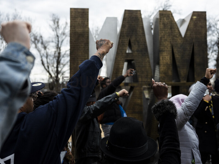Protesters raise their fists as they march through the I AM A MAN Plaza in downtown Memphis, Tenn. on Saturday, Jan. 28, 2023, one day after the city of Memphis released video of several police officers beating Tyre Nichols. (Brad Vest/The New York Times