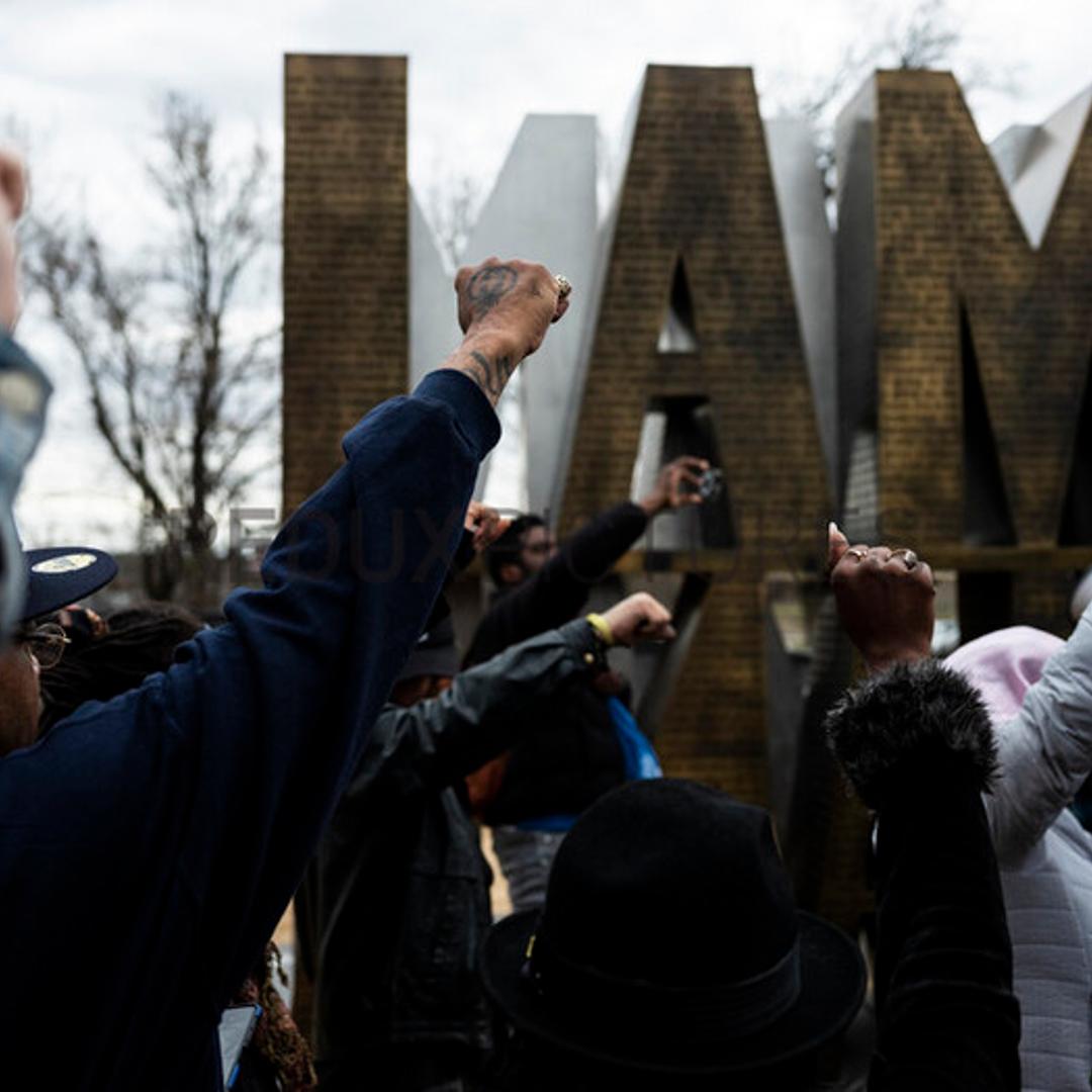Protesters raise their fists as they march through the I AM A MAN Plaza in downtown Memphis, Tenn. on Saturday, Jan. 28, 2023, one day after the city of Memphis released video of several police officers beating Tyre Nichols. (Brad Vest/The New York Times