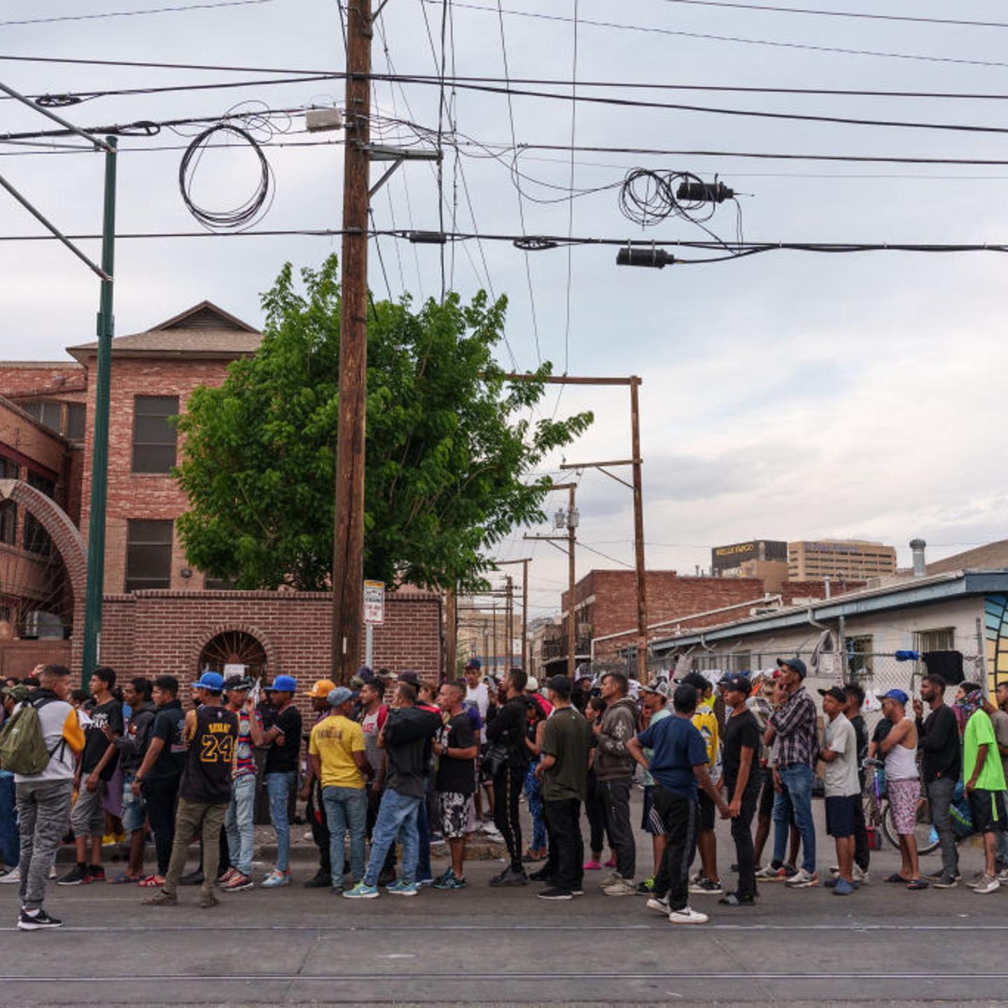 Migrants wait in line for donations outside of Sacred Heart Church before the lifting of Title 42