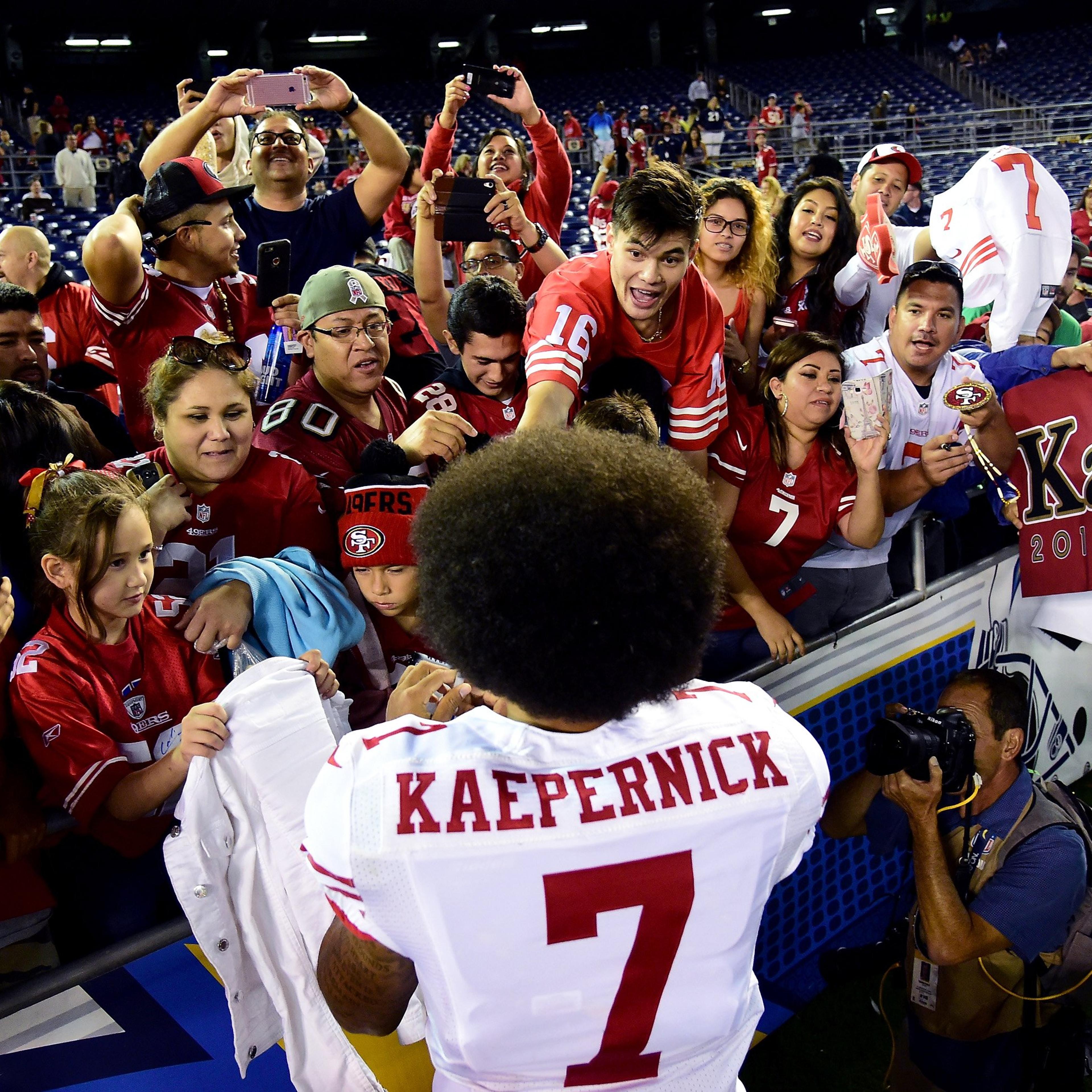 Colin Kaepernick of the San Francisco 49ers signs autographs for fans after a 31-21 win over the San Diego Chargers during a preseason game at Qualcomm Stadium on Sept. 1, 2016 in San Diego.
