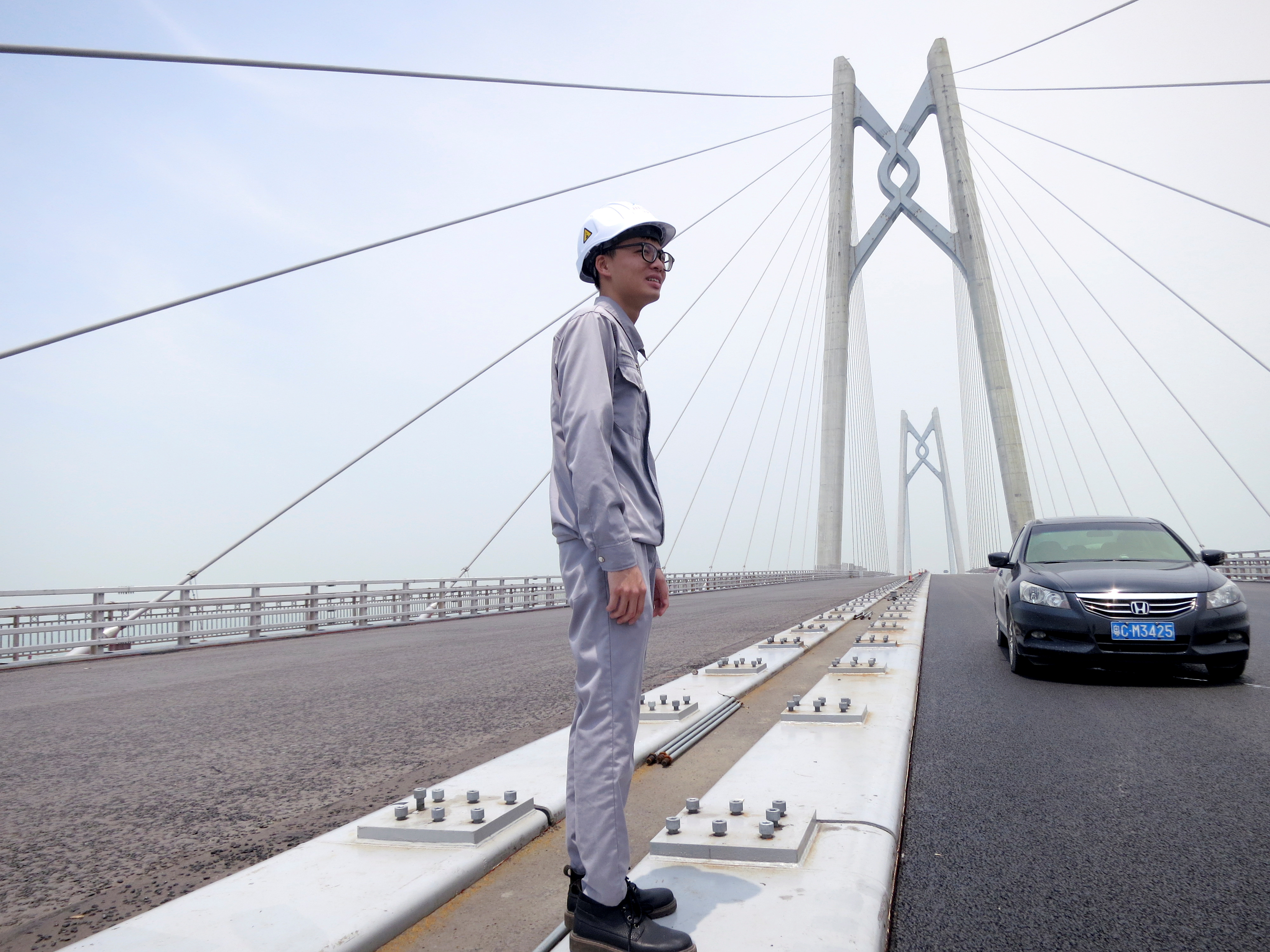 A worker stands on the Hong Kong-Zhuhai-Macau bridge under construction in Zhuhai