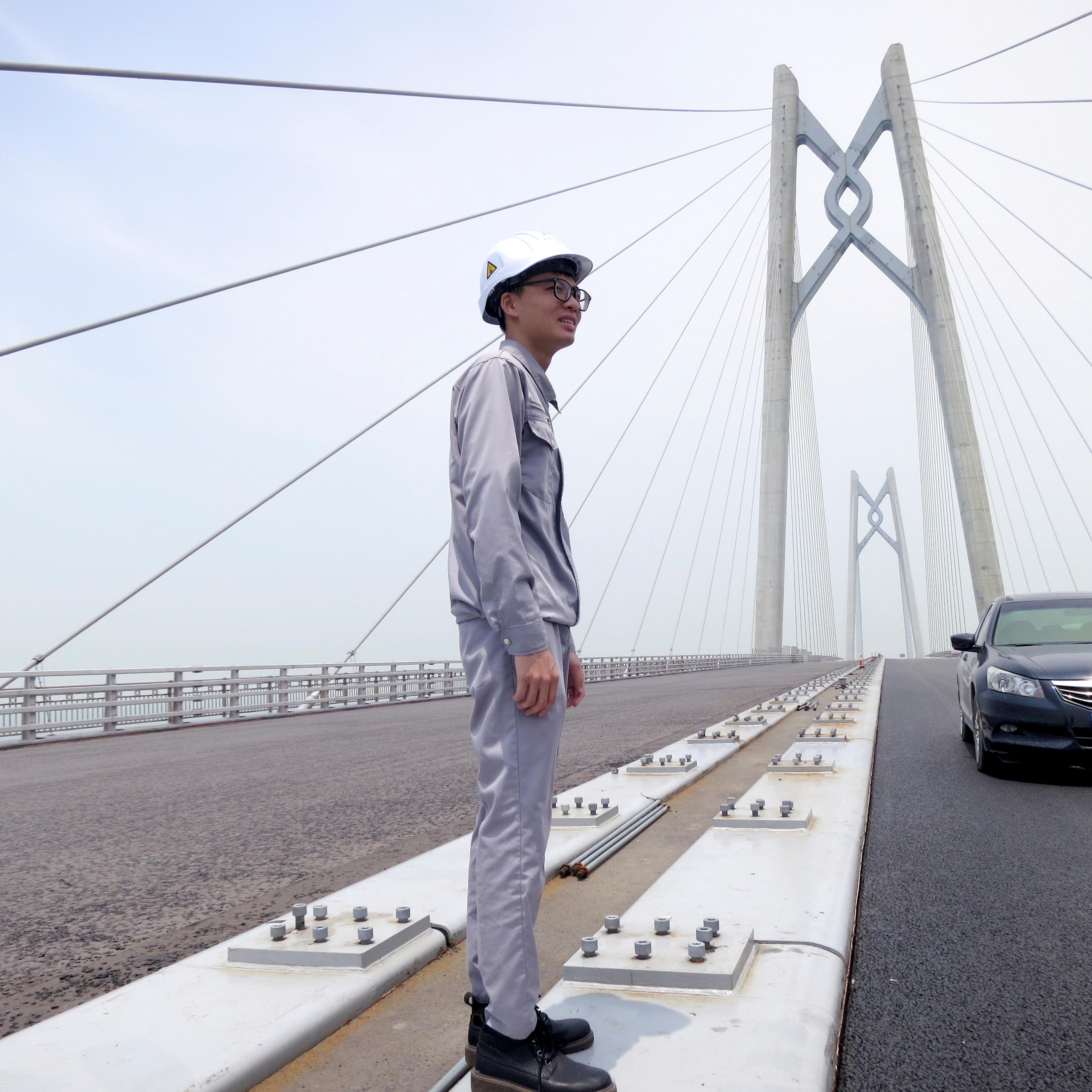 A worker stands on the Hong Kong-Zhuhai-Macau bridge under construction in Zhuhai