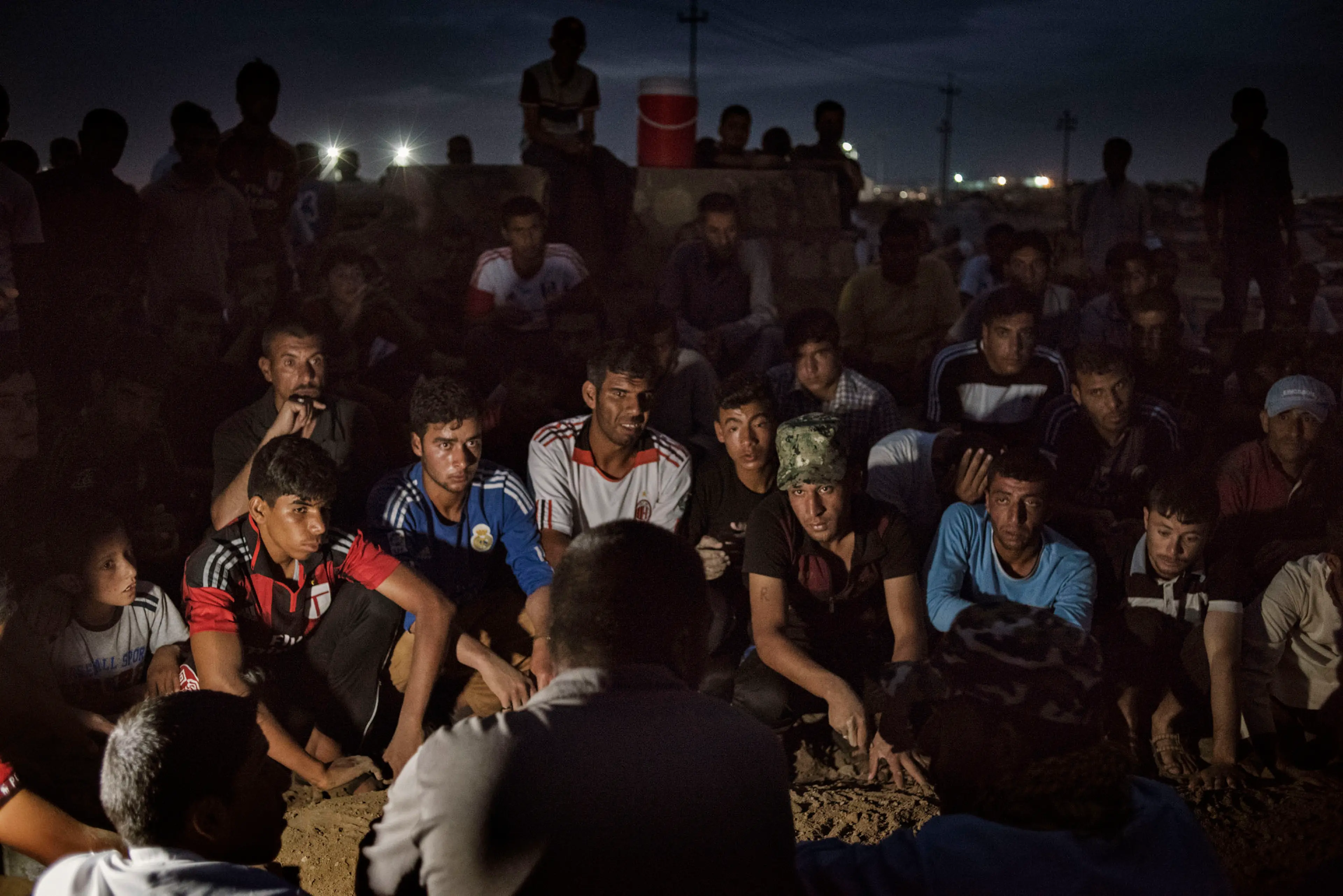 Men and boys dig a grave for a man named Ahmed Mohamed Ali, in a camp for internally displaced people (IDP's) near the Iraqi town of Makhmour, May 17, 2016. According to camp residents, Ali had been injured during the Iraqi military's offensive on ISIS-h