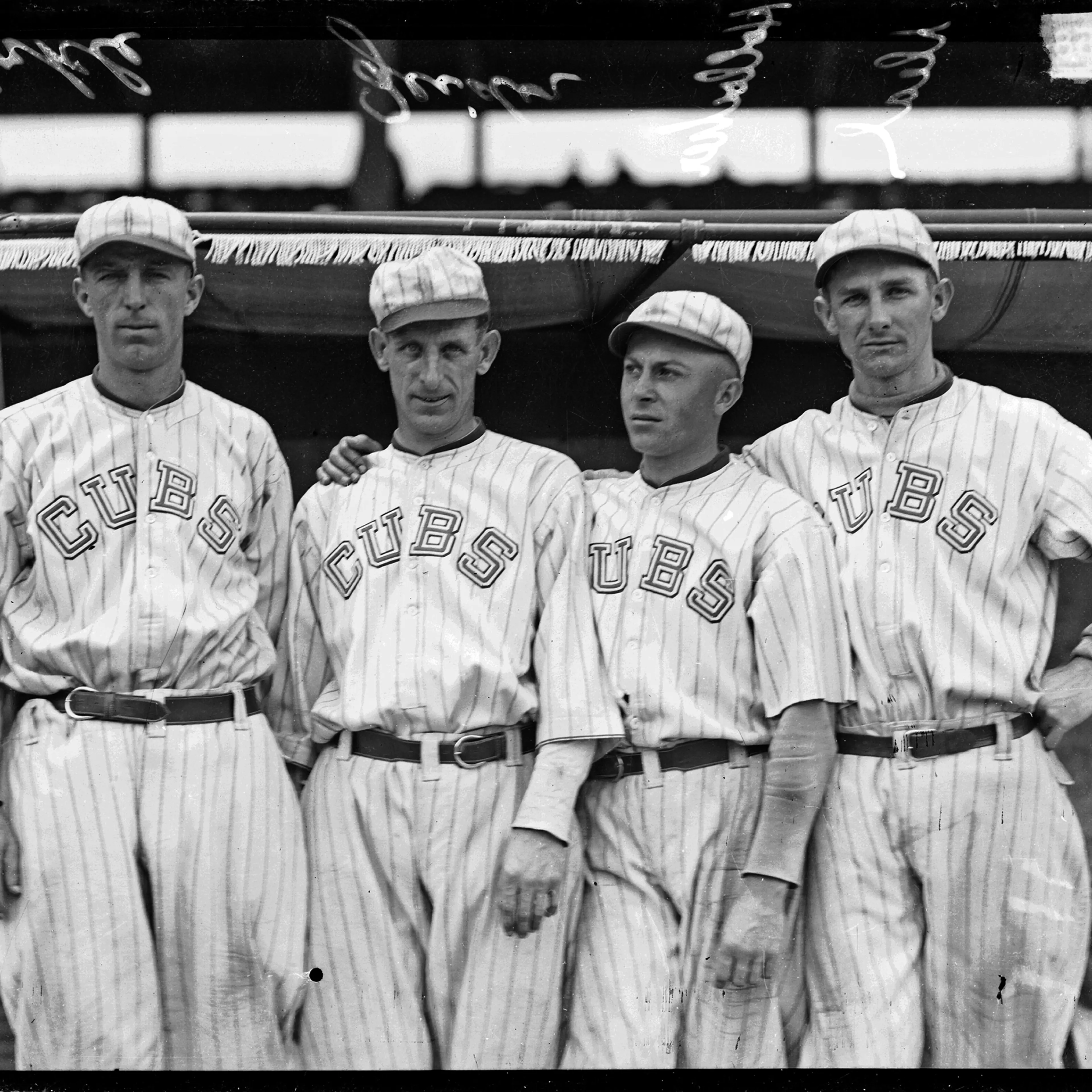 Chicago Cubs baseball players Merkle, Zeider, Charles Hollocher, and Deal standing in front of a dugout at Weeghman Park, Chicago, Illinois, 1918.