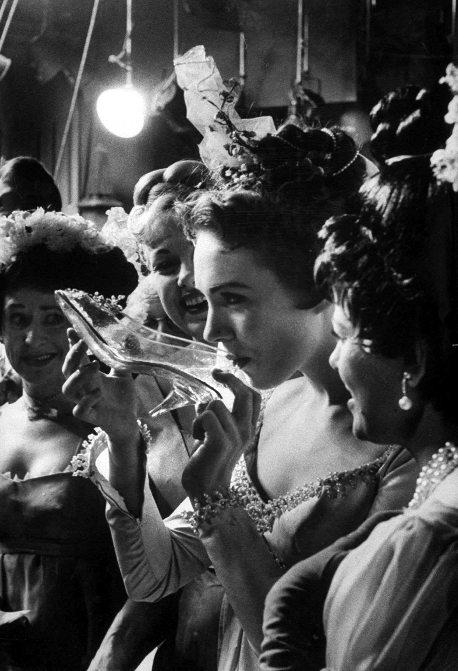 Julie Andrews taking a sip from the glass slipper during the TV production of "Cinderella".