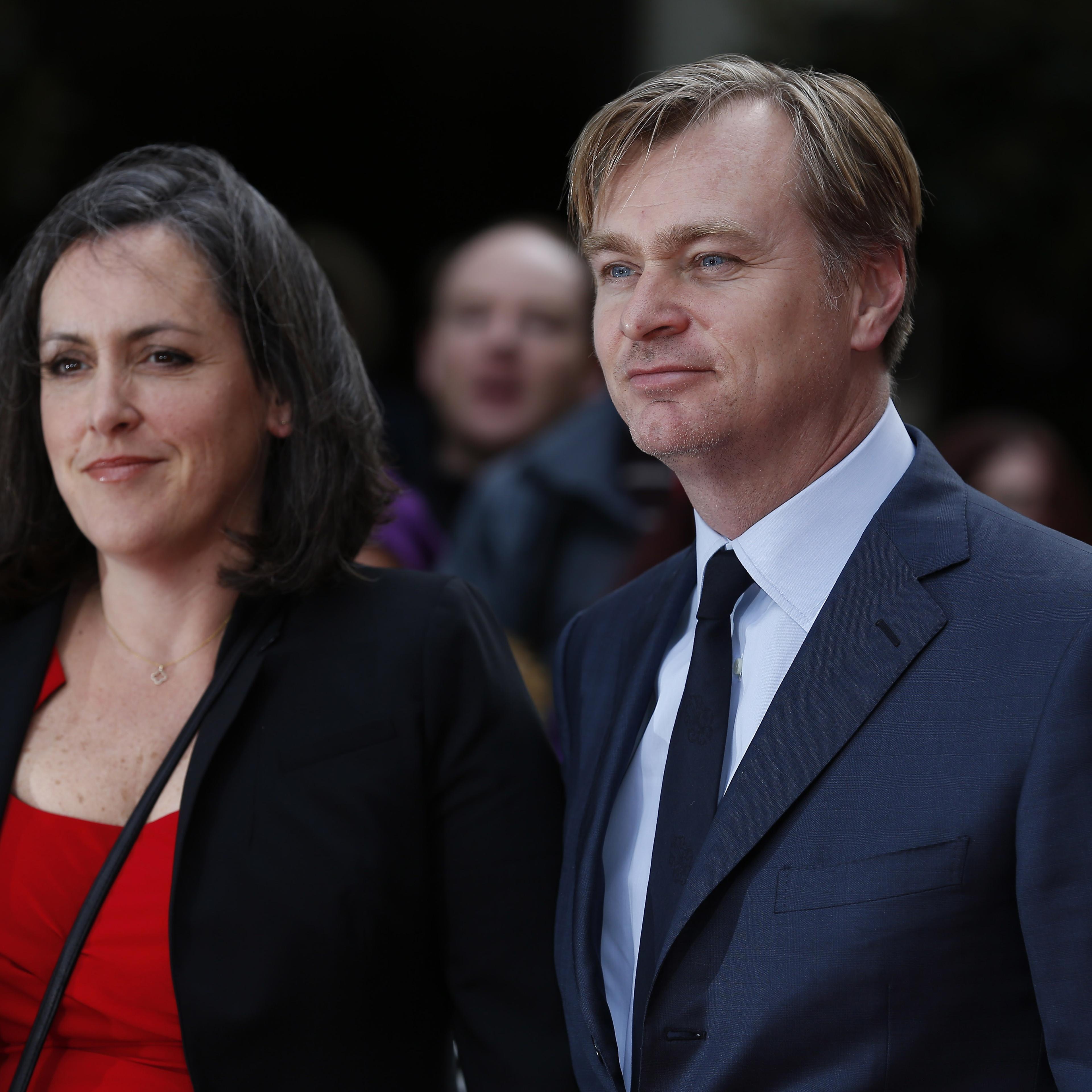 British director Christopher Nolan (R) and his wife, British film producer Emma Thomas pose for photographers as they arrive for the 2015 Empire Awards in central London on Mar. 29, 2015.