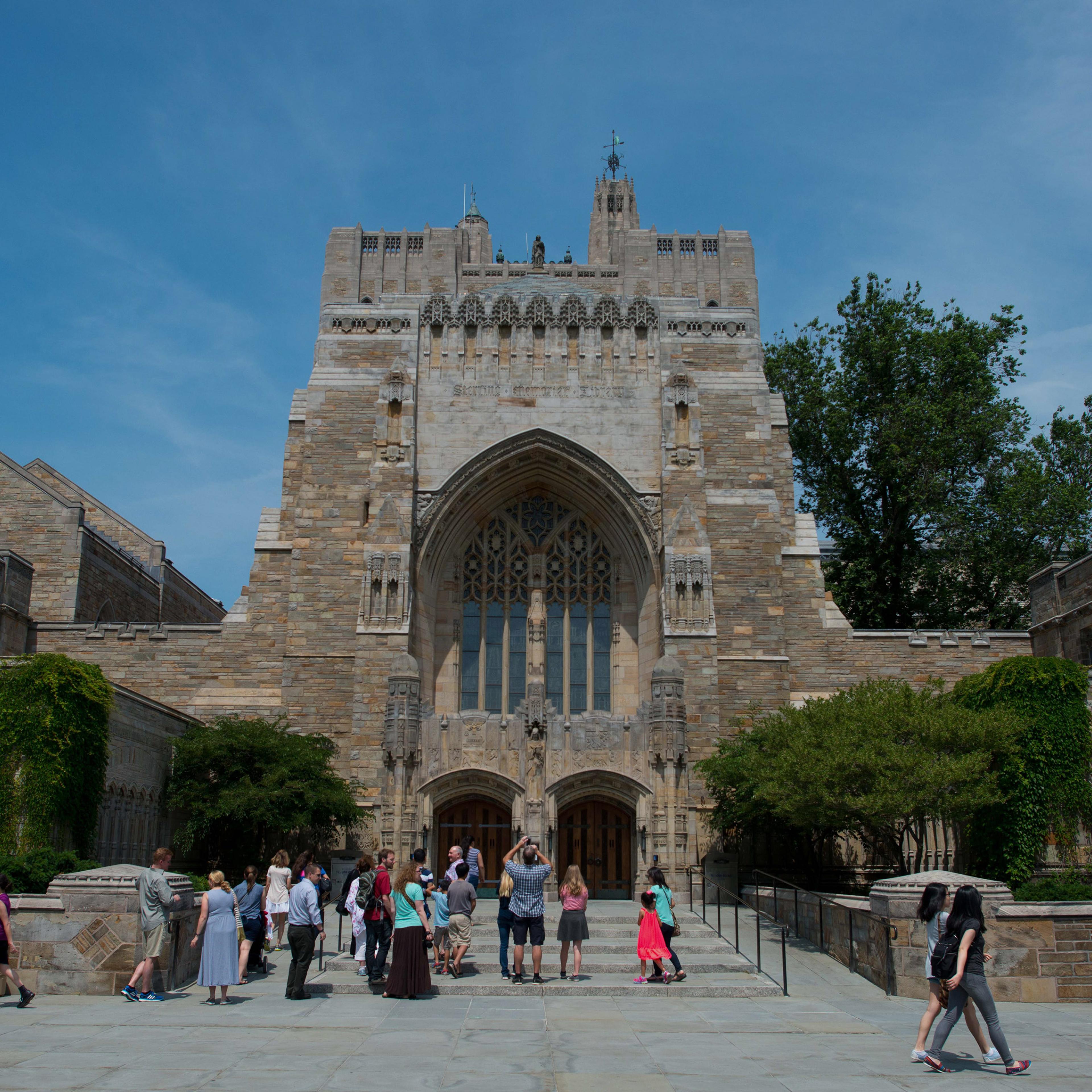 A tour group makes a stop at the Sterling Memorial Library on the Yale University campus in New Haven, Conn., on June 12, 2015.