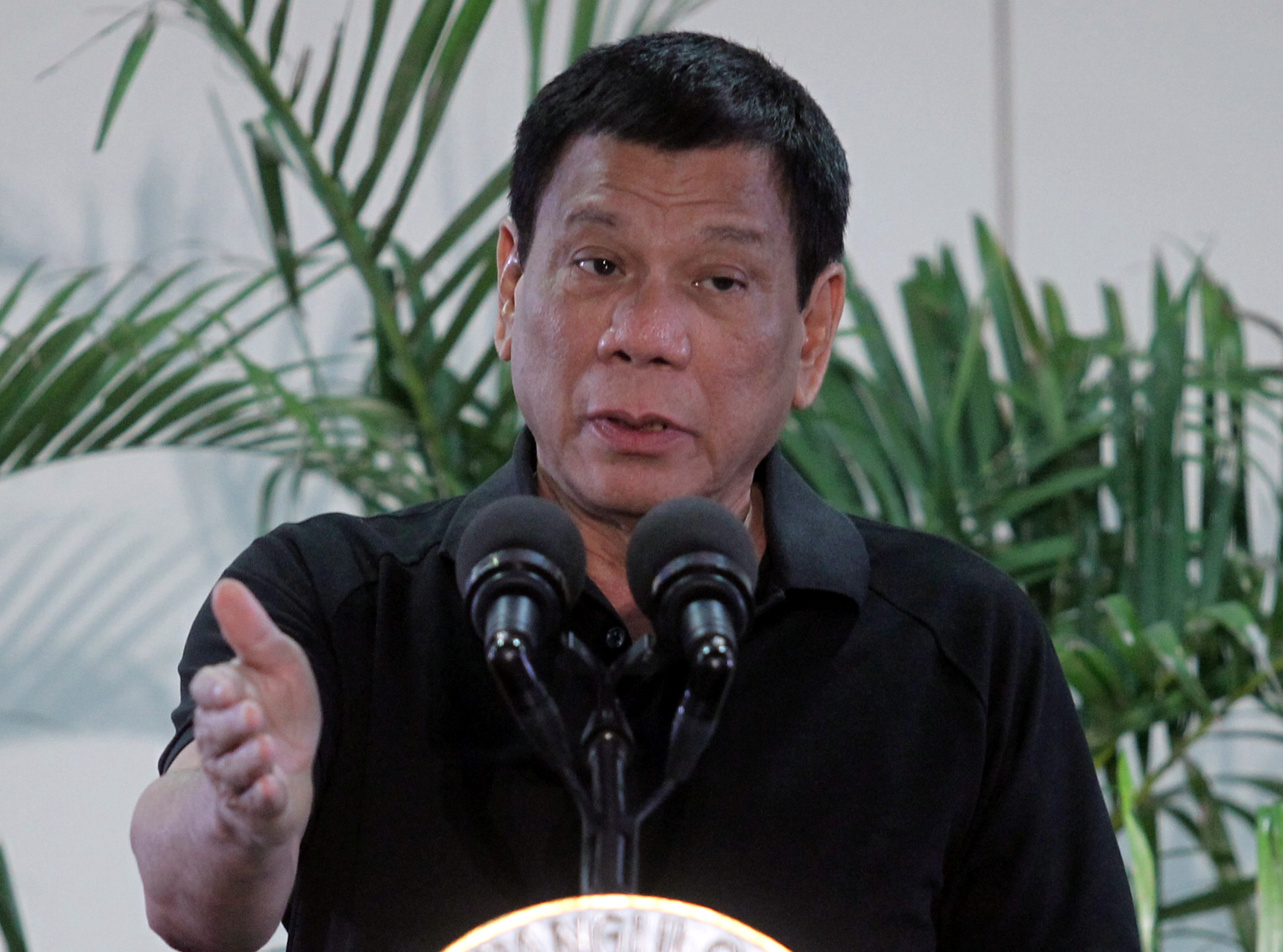 Philippines President Rodrigo Duterte gestures during a news conference upon his arrival from Vietnam trip at the International Airport in Davao city