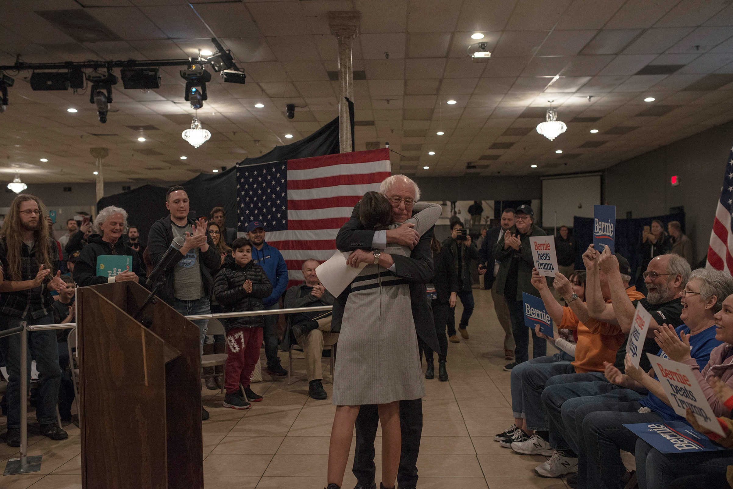 Democratic presidential candidate Sen. Bernie Sanders hugs Rep. Alexandria Ocasio-Cortez at a town hall in Marshalltown, Iowa, Jan. 26, 2020.