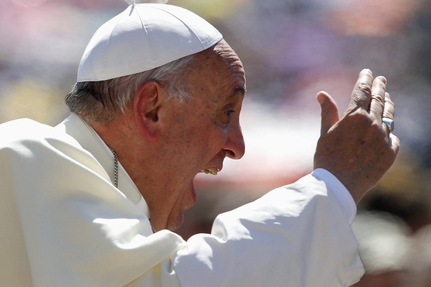 Pope Francis waves as he arrives to lead the weekly audience in Saint Peter's Square at the Vatican