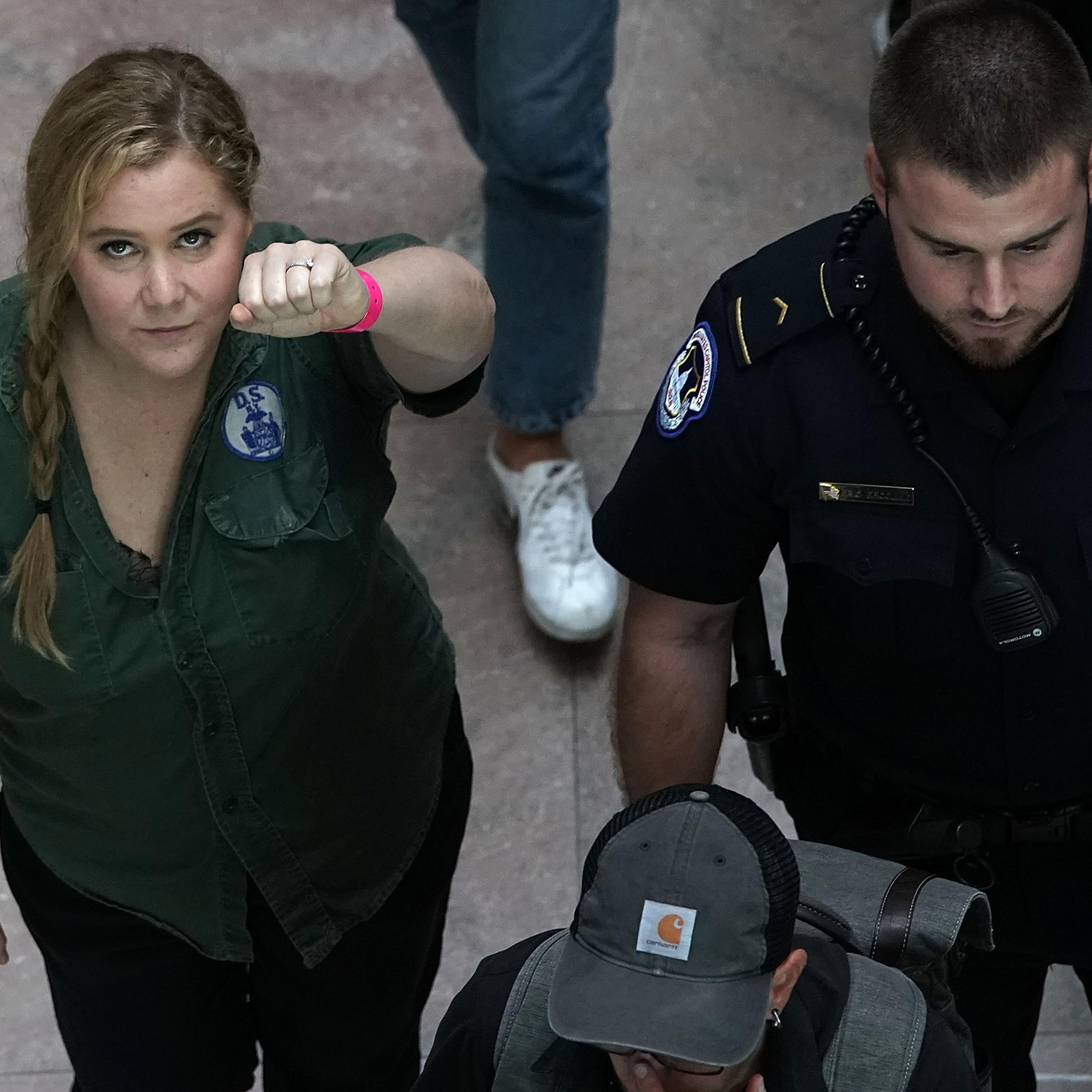 WASHINGTON, DC - OCTOBER 04: Comedian Amy Schumer (L) is led away after she was arrested during a protest against the confirmation of Supreme Court nominee Judge Brett Kavanaugh October 4, 2018 at the Hart Senate Office Building on Capitol Hill in Washin