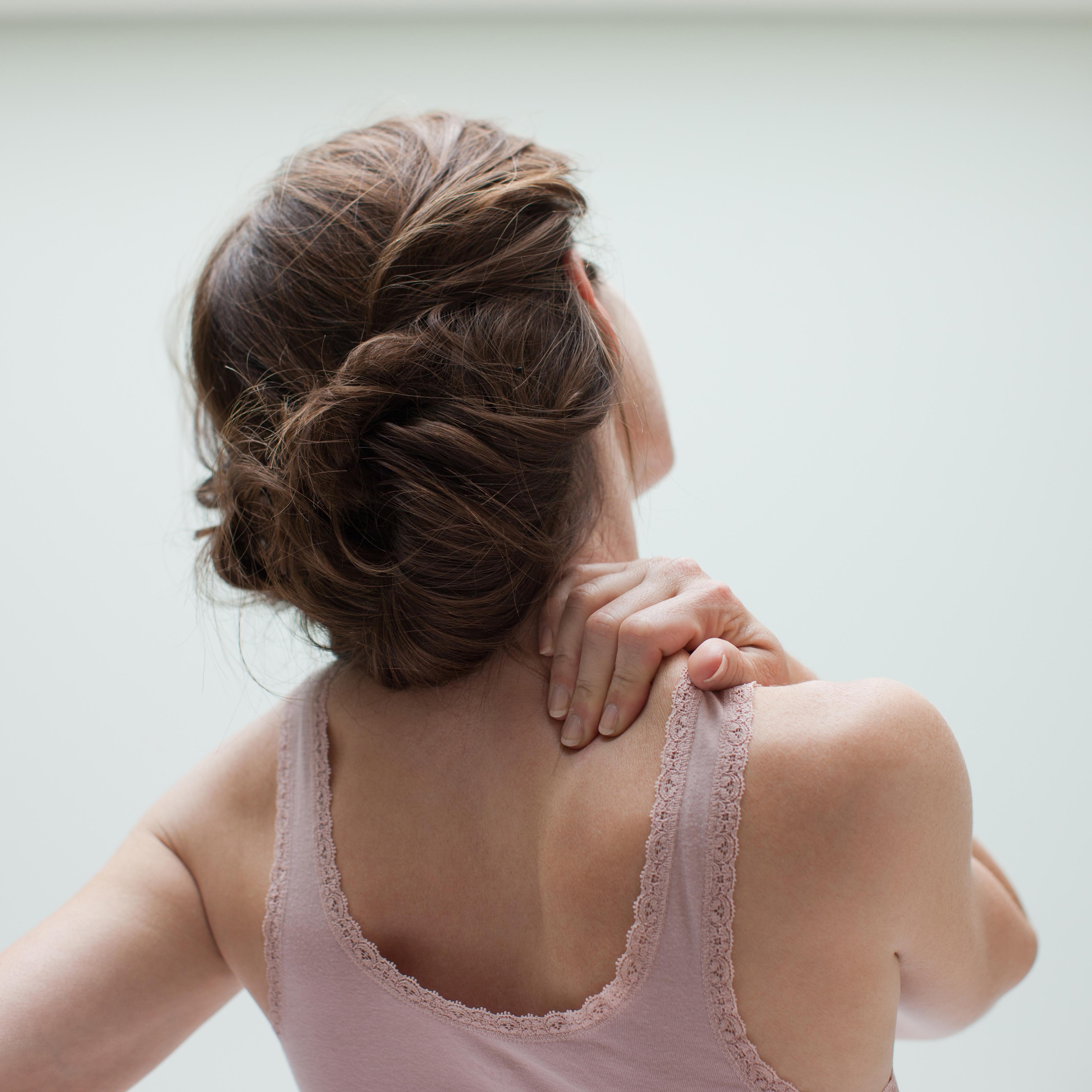 Woman rubbing aching back