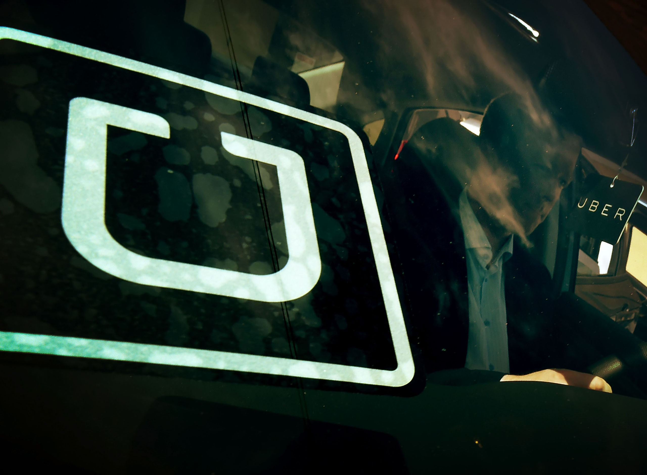 A man checking a vehicle at the first of Uber's 'Work On Demand' recruitment events in South Los Angeles, March 10, 2016.