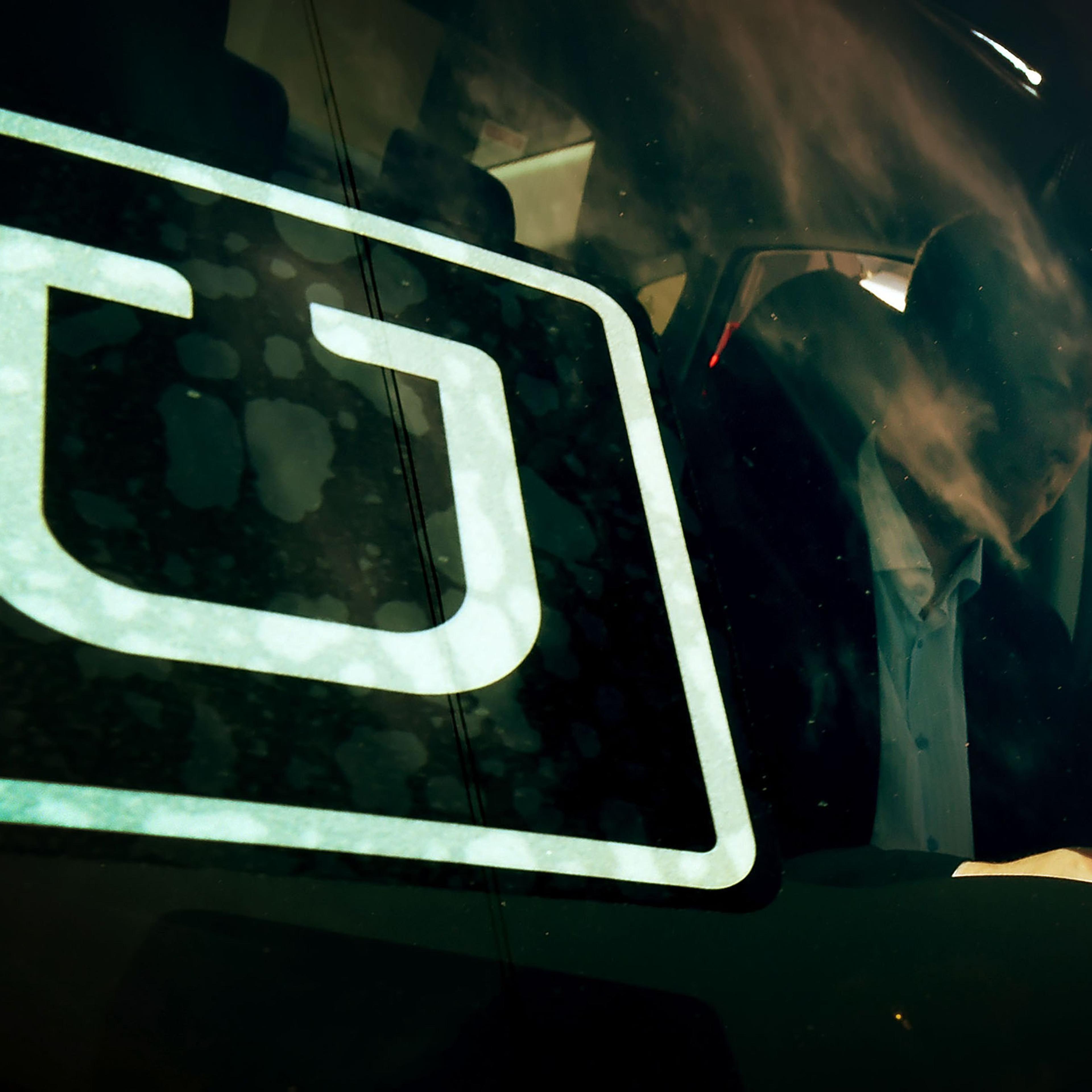 A man checking a vehicle at the first of Uber's 'Work On Demand' recruitment events in South Los Angeles, March 10, 2016.