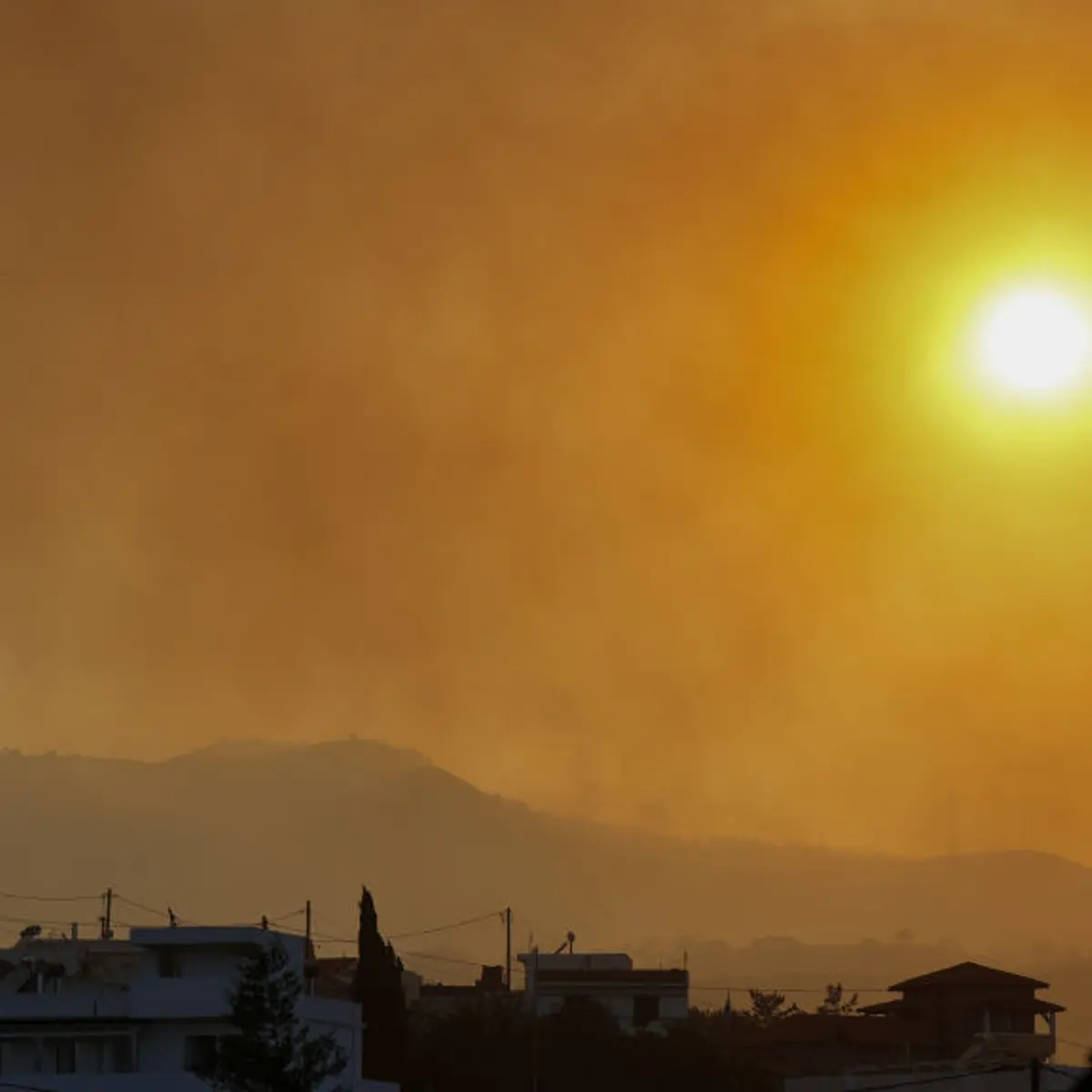 Smoke rises as teams try to extinguish wildfires on Rhodes island, Greece on July 25, 2023.