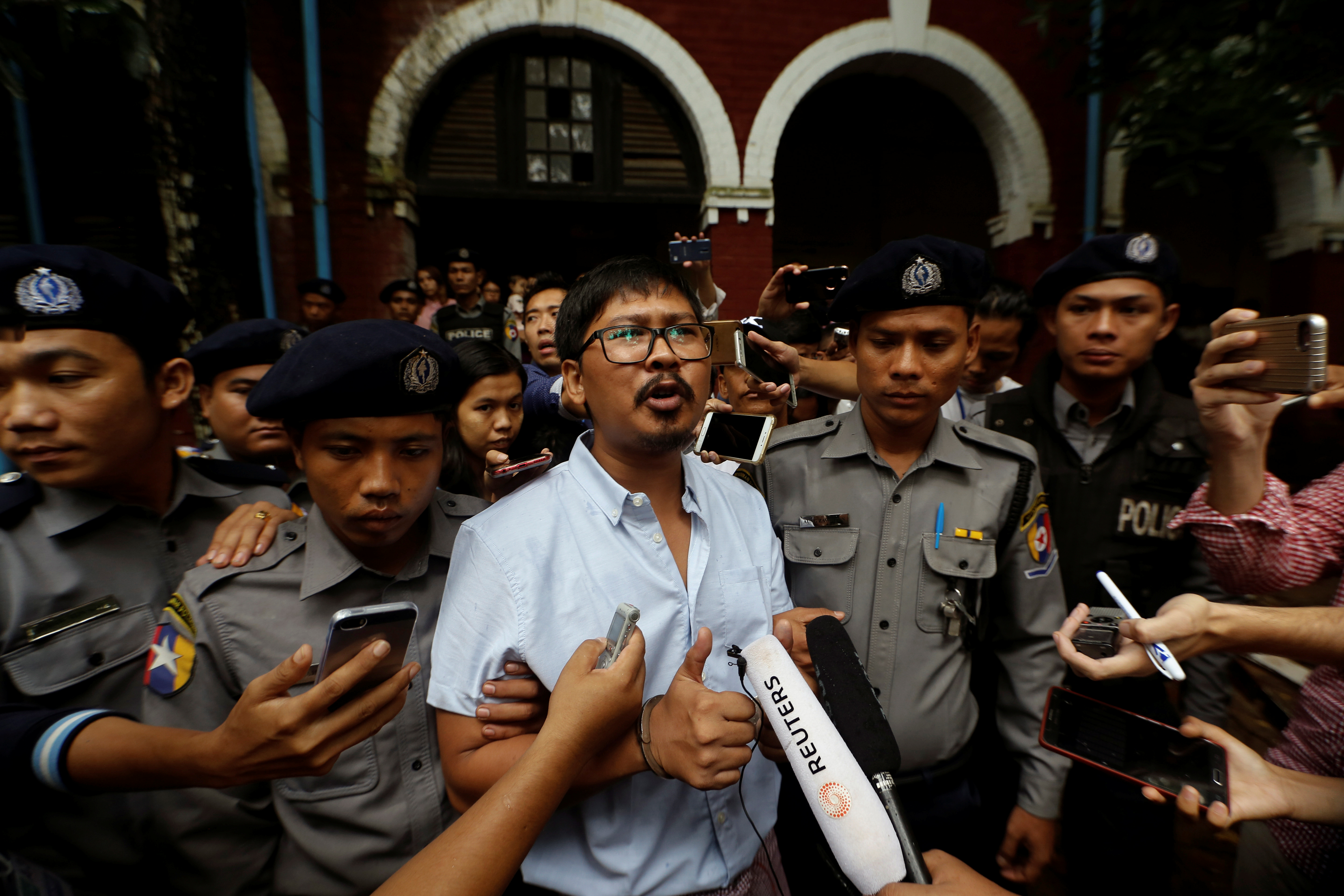Detained Reuters journalist Wa Lone speaks to the media while leaving Insein court in Yangon