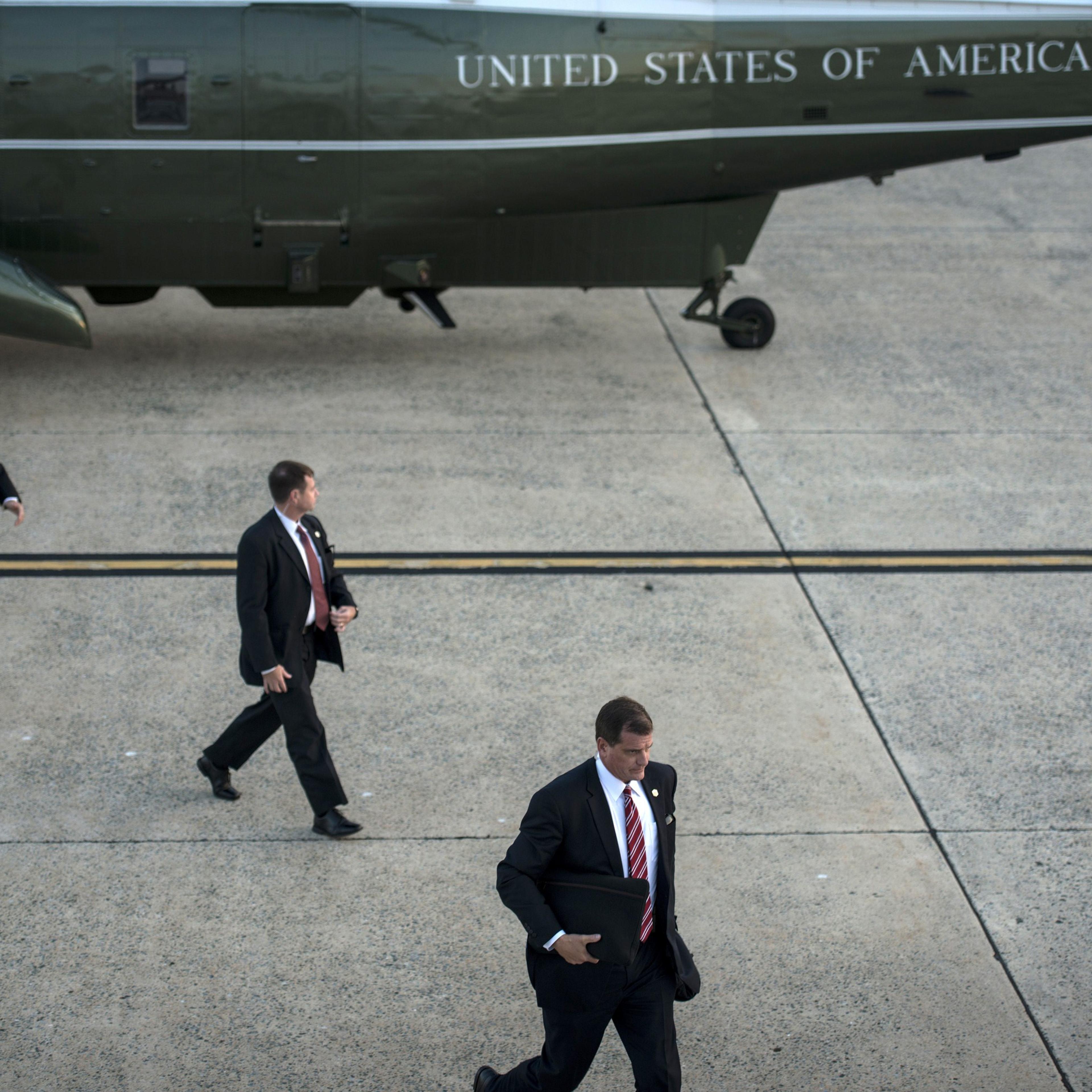 Members of the US Secret Service arrive to escort President Barack Obama on a trip at Andrews Air Force Base on Oct. 1, 2014 in Maryland.