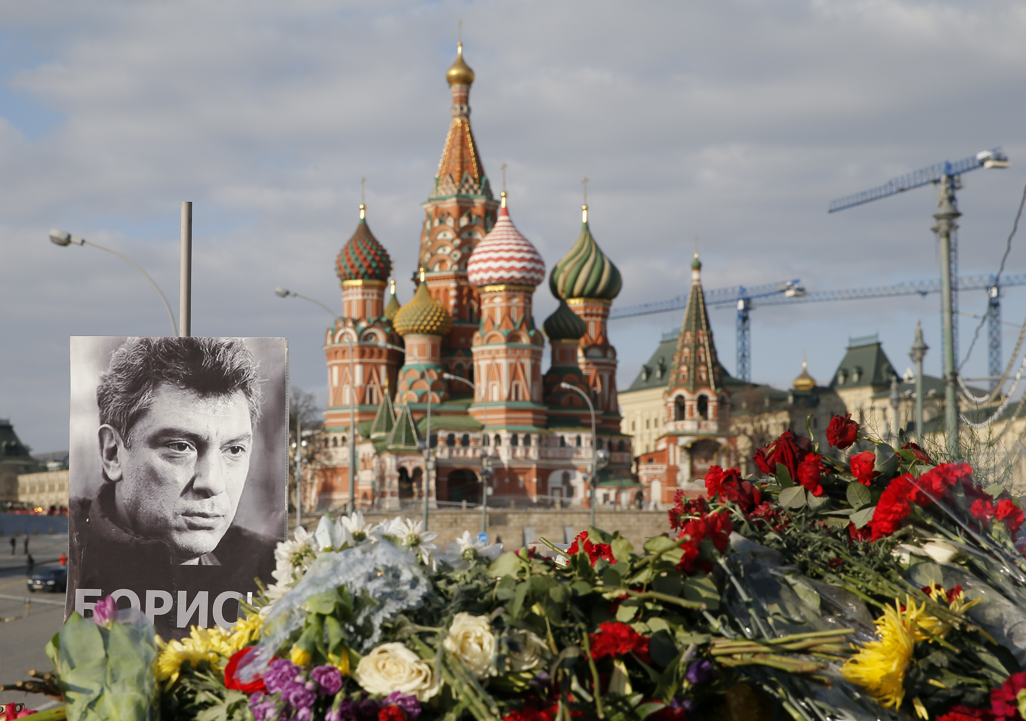 A portrait of Kremlin critic Boris Nemtsov and flowers are pictured at the site where he was killed on Feb. 27, 2015 with St. Basil's Cathedral seen in the background, at the Great Moskvoretsky Bridge in central Moscow on March 6, 2015.